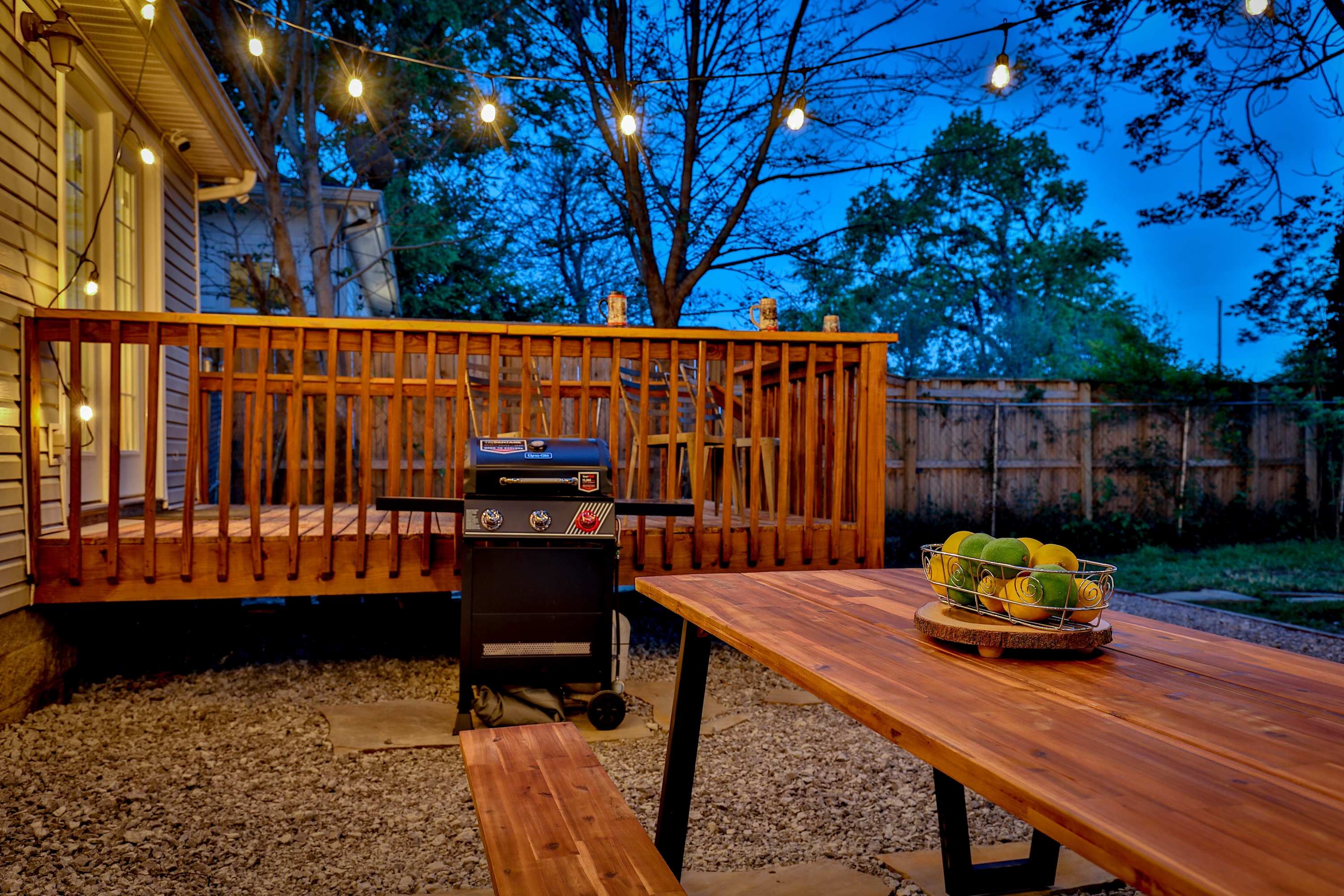 Back yard with grill, outdoor seating, and fire pit area
