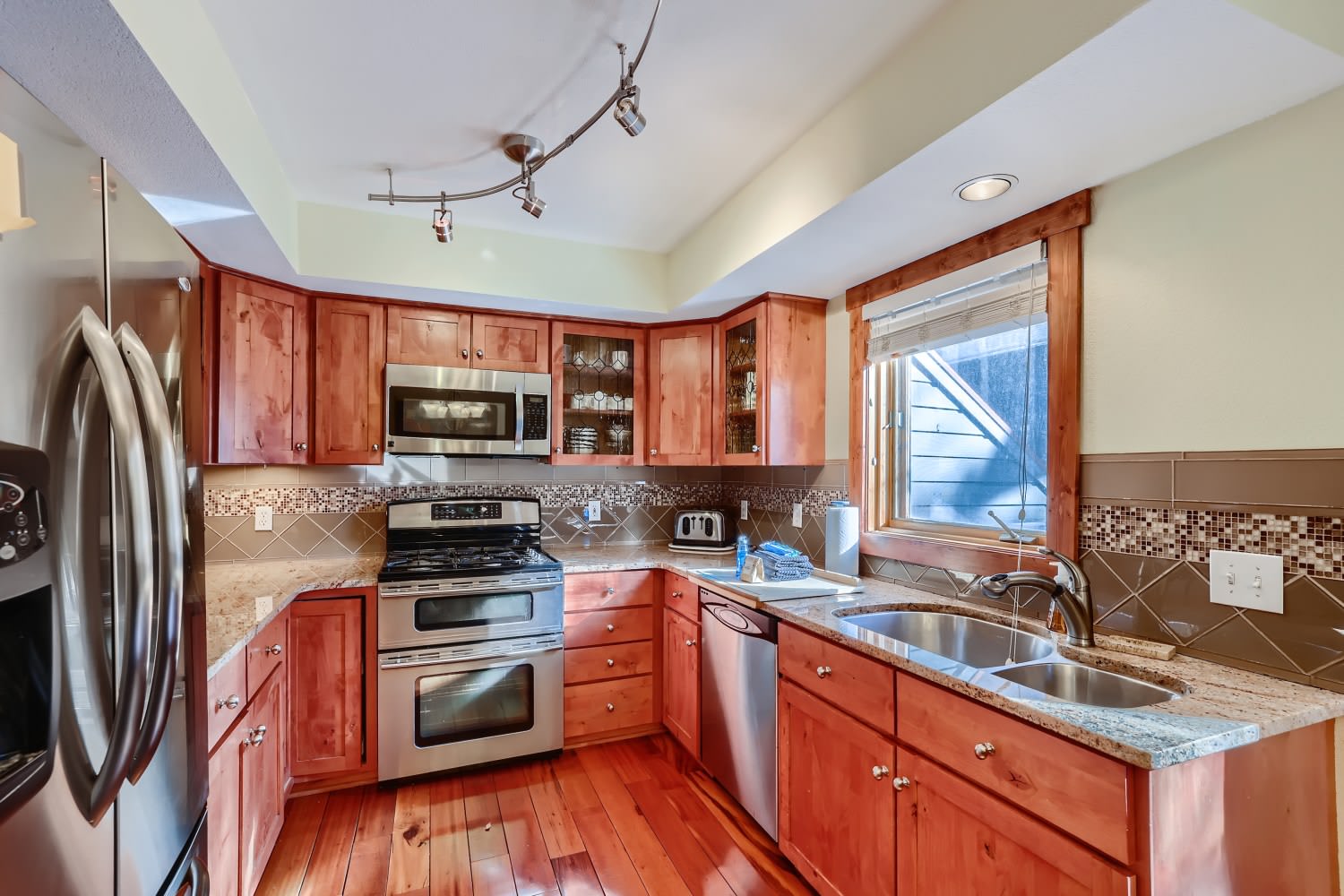 Full kitchen with drip coffee maker, toaster, and dishwasher