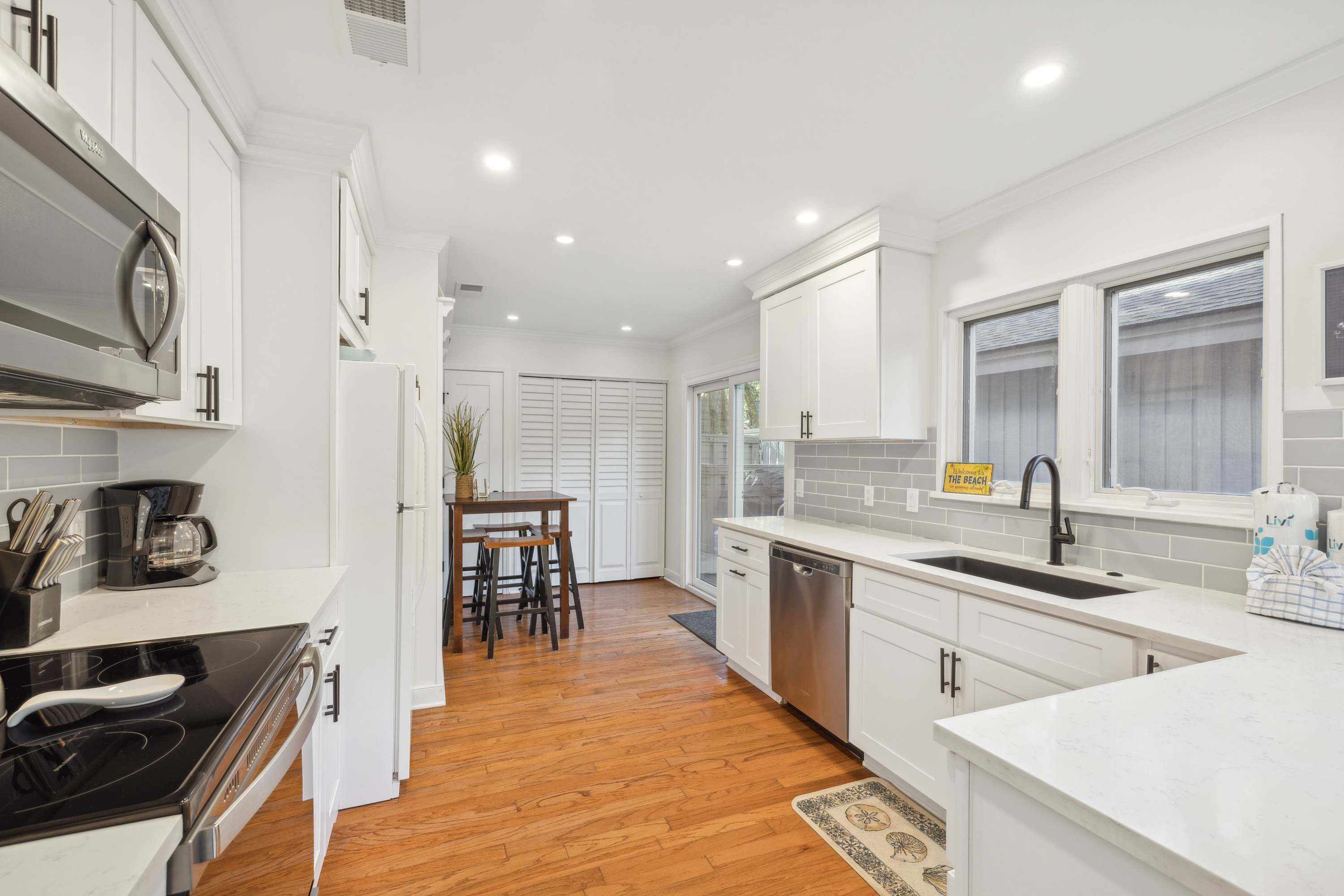 The airy kitchen offers ample space & all the comforts of home