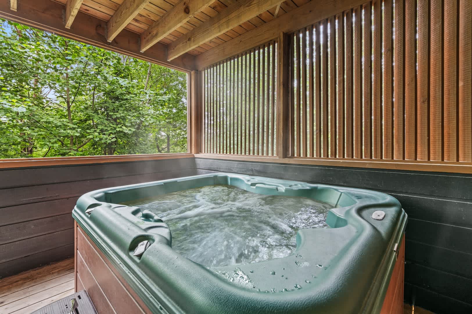 A secluded hot tub offering a tranquil escape surrounded by nature
