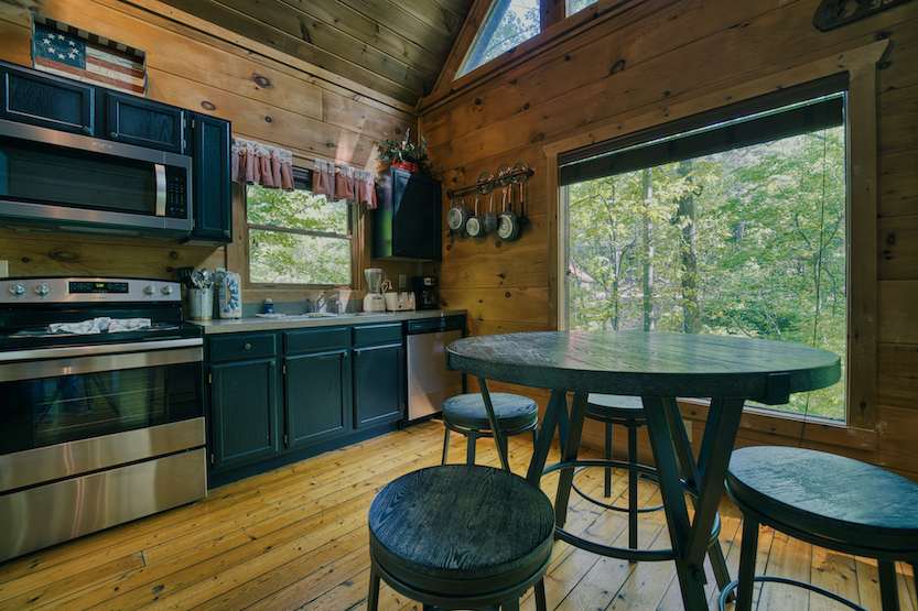 Gather for meals with treetop views together at the dining table, seating 4