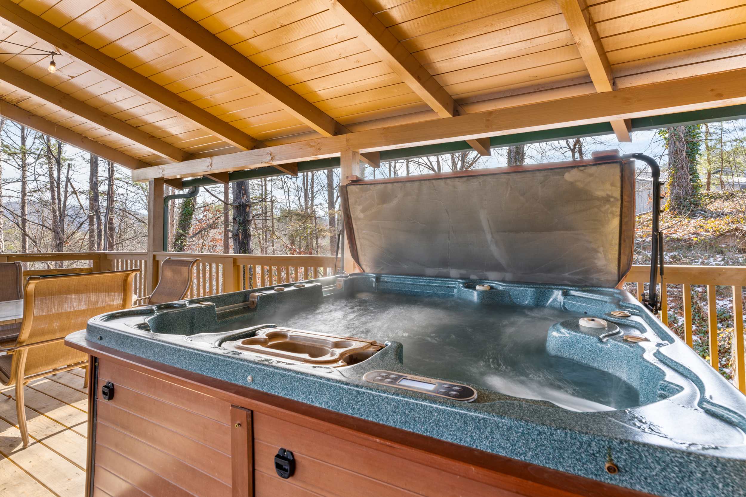 Spacious deck with outdoor seating, firepit, grill, hot tub, and slide 