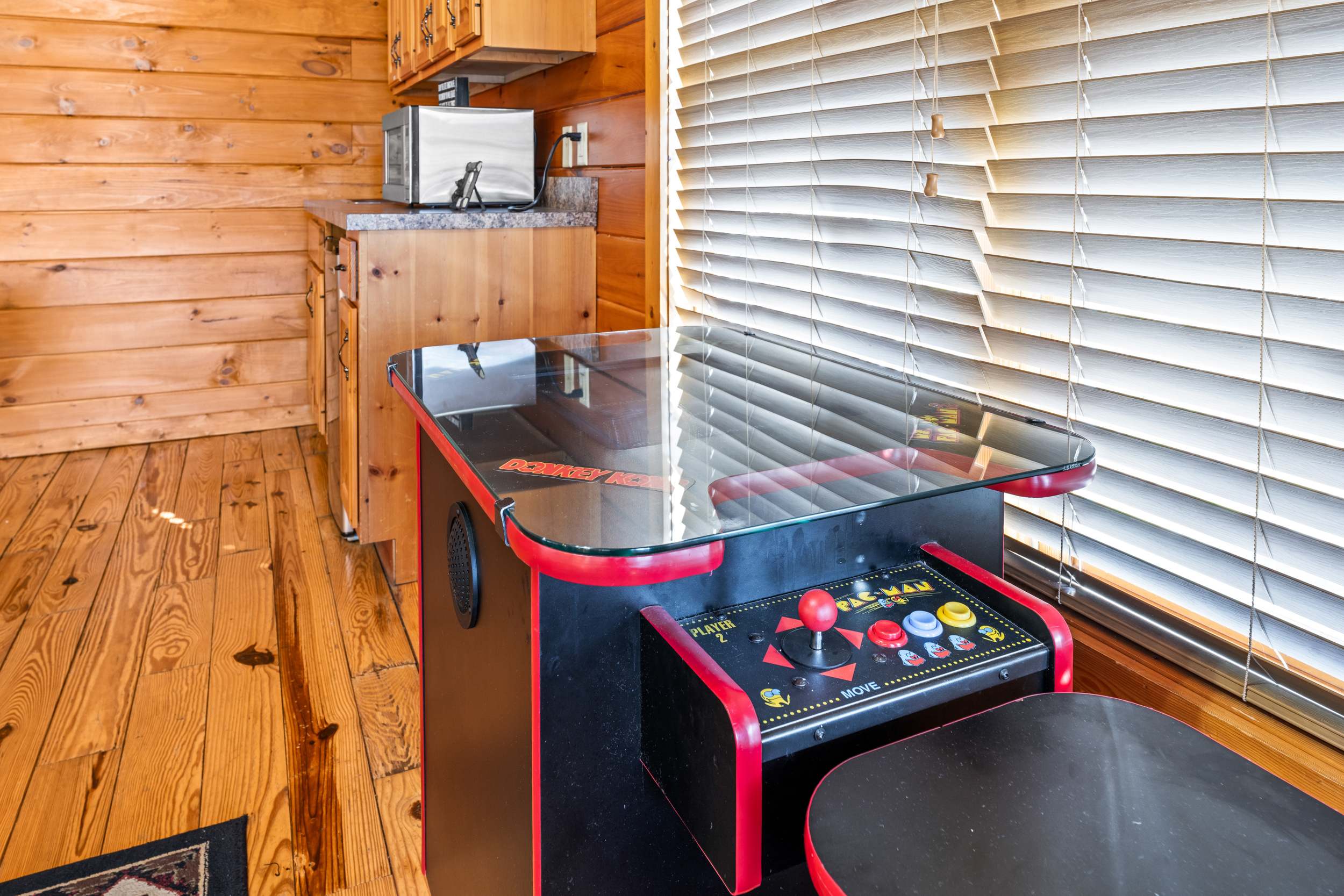 Game room with pool table, arcade games, kitchenette, sofa sleeper, Smart TV, and deck access