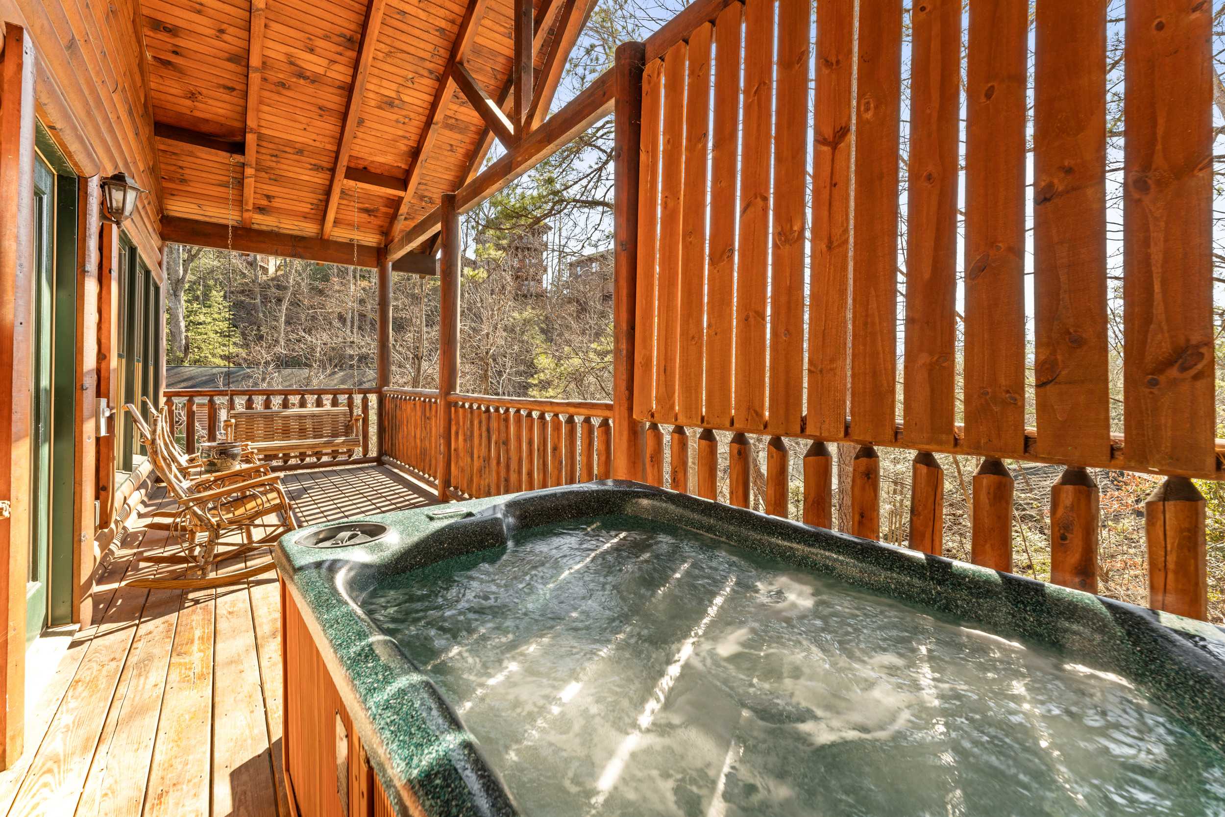 Deck off of the game room with hot tub, and outdoor seating 