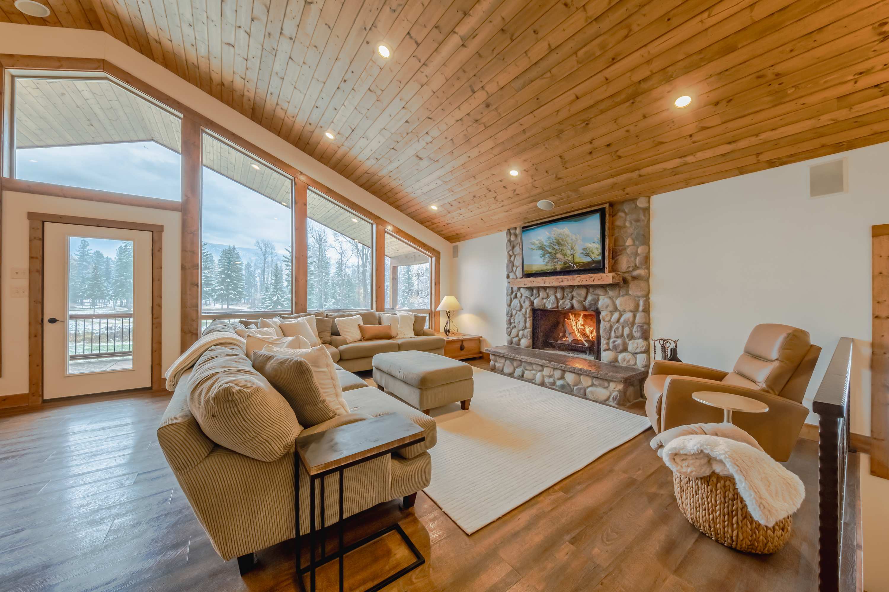 Bright open living space with sectional seating, and Smart TV