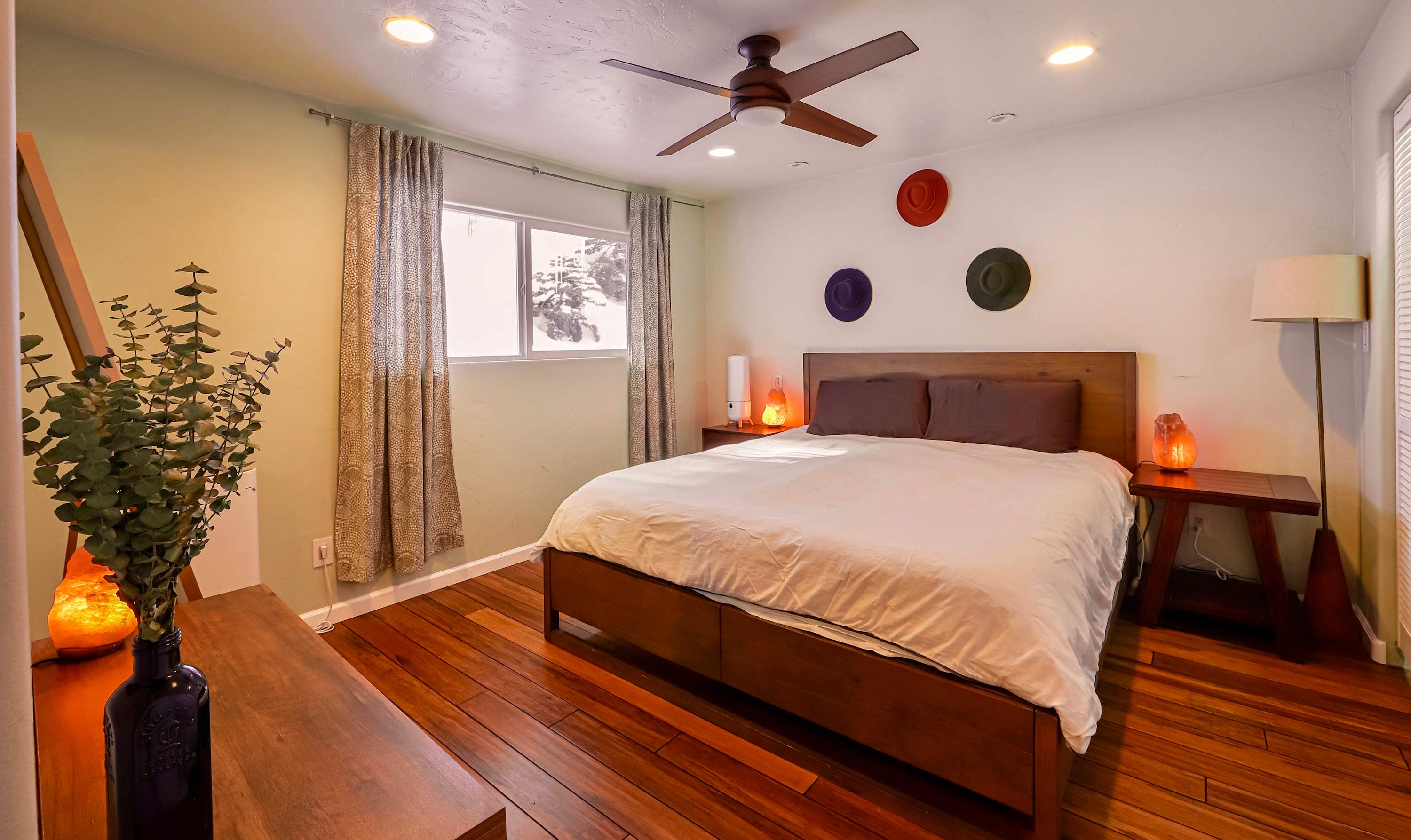 Luxurious king ensuite featuring a spacious bed, stylish décor with ceiling fan​