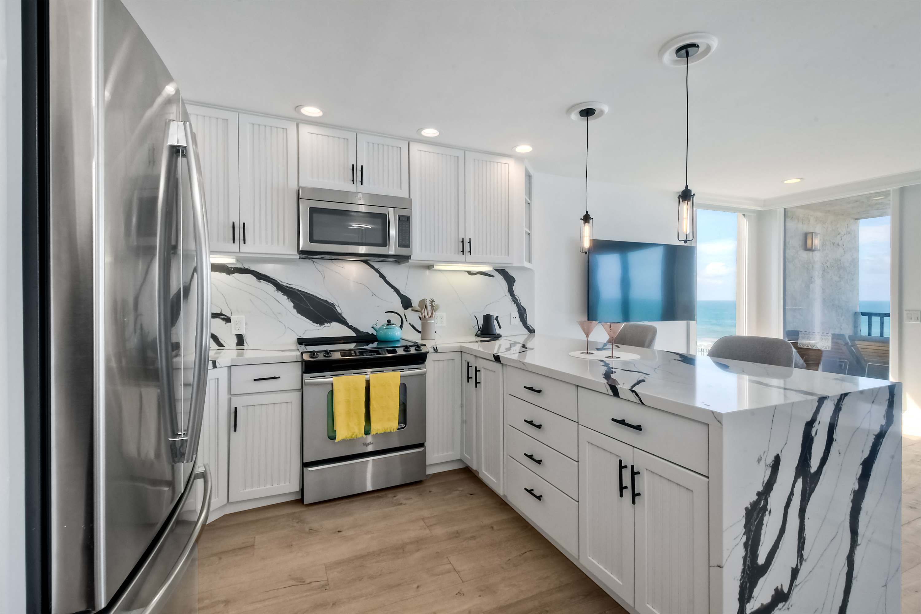 The chic, open kitchen offers ample space & all the comforts of home