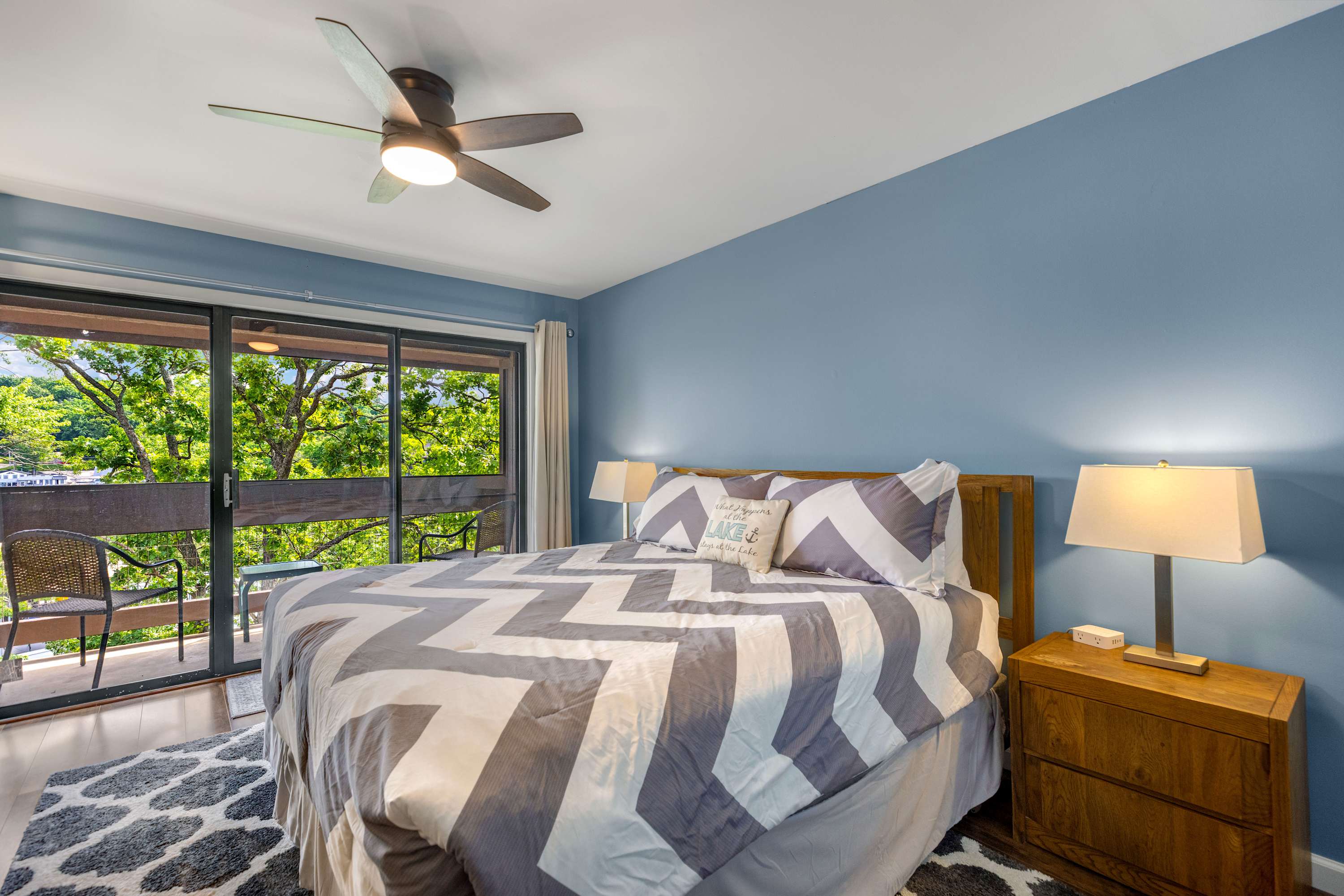 The primary king suite boasts a private ensuite, smart TV, & balcony access