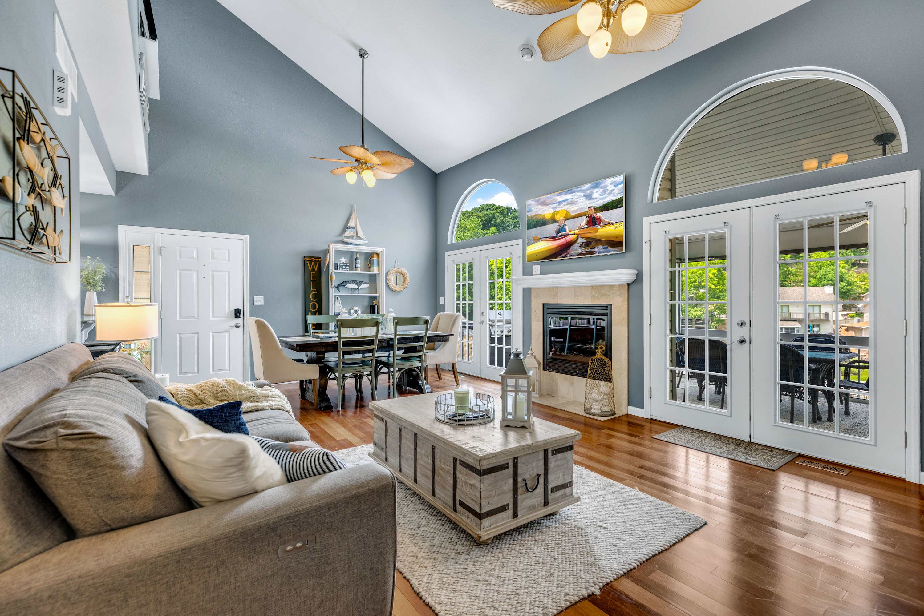 Cozy open-concept living room featuring a gas fireplace and direct access to the screened-in deck