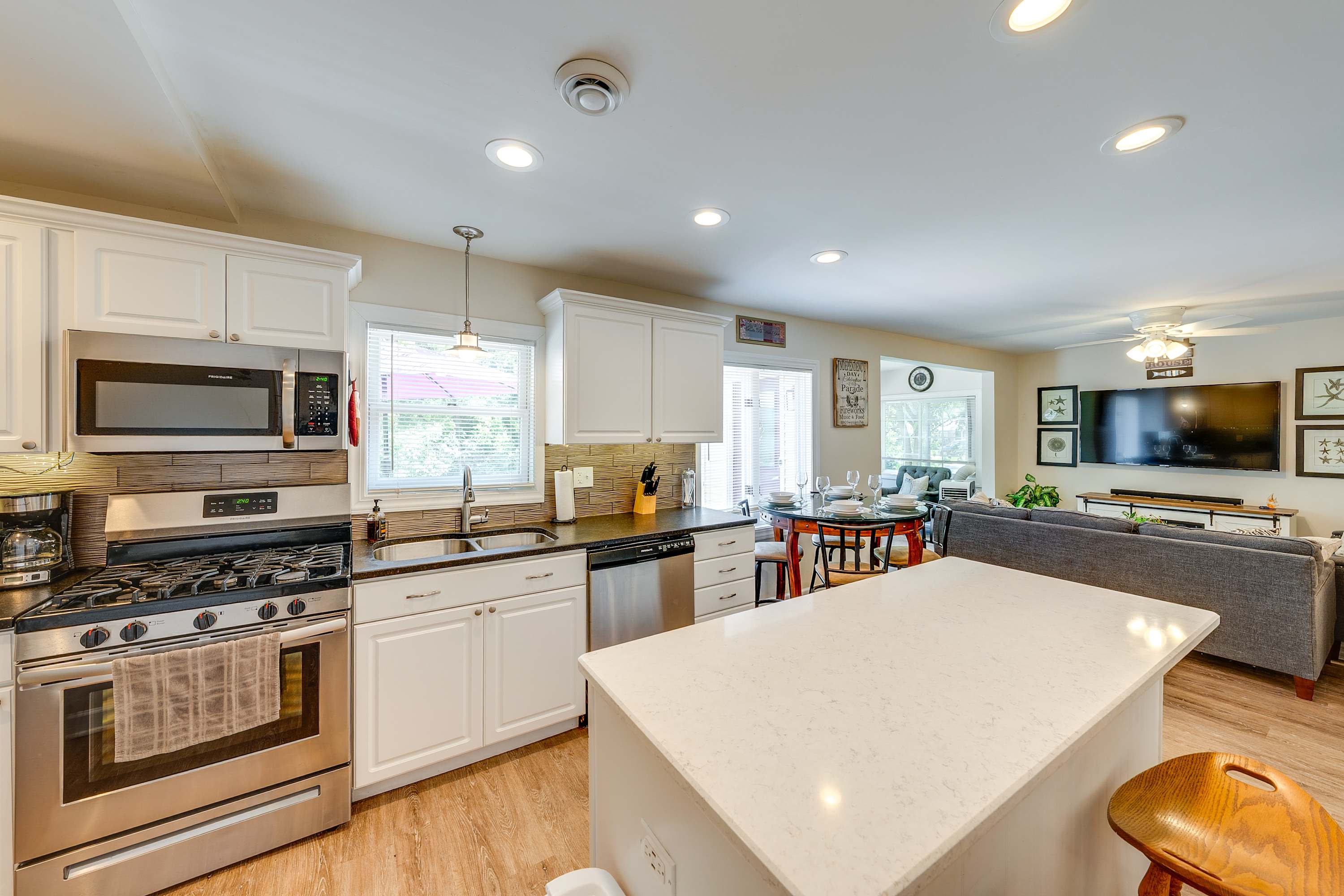 The breezy, open kitchen offers ample space & every home comfort​