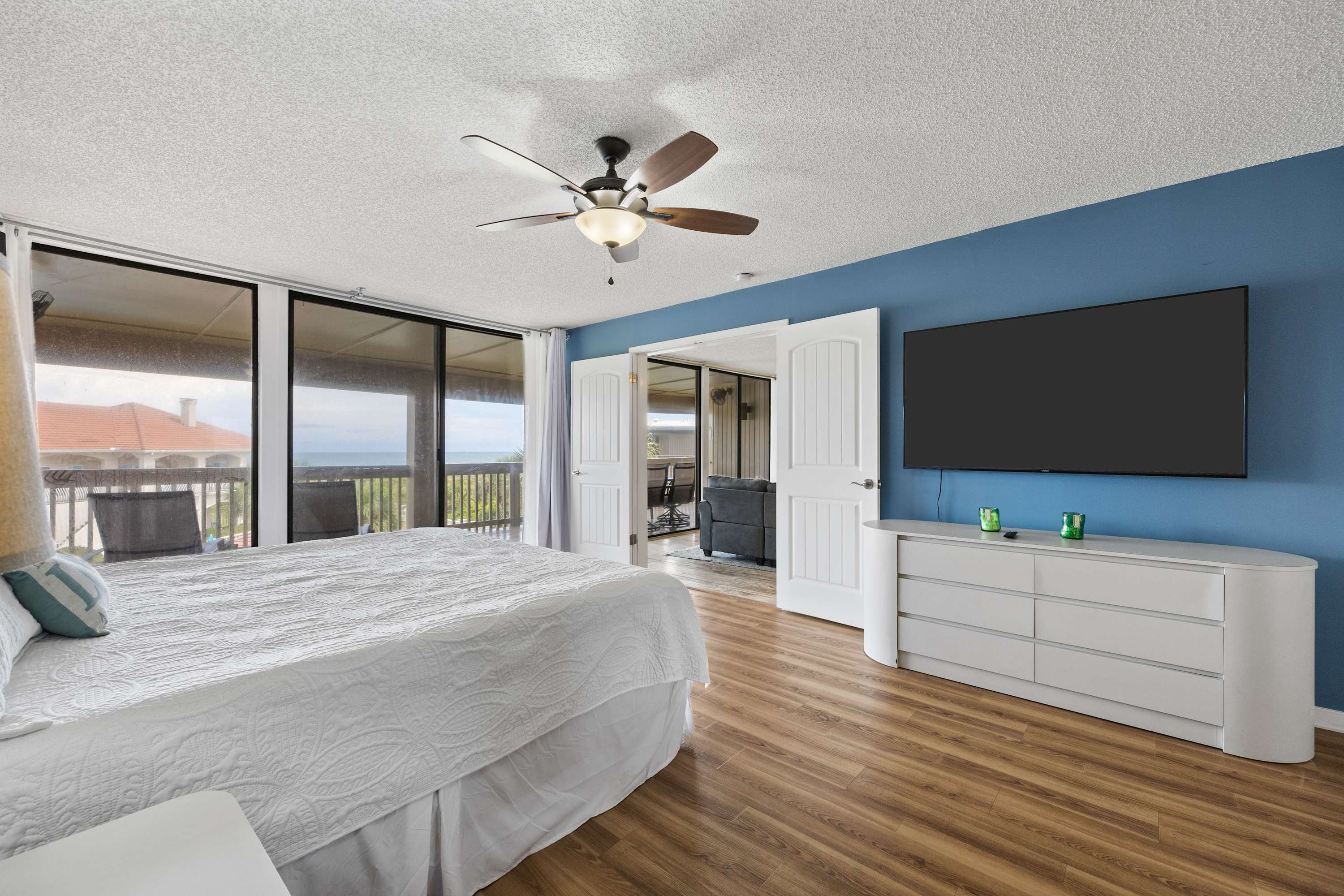 The king suite boasts balcony access, a private en suite, Peloton, & Smart TV