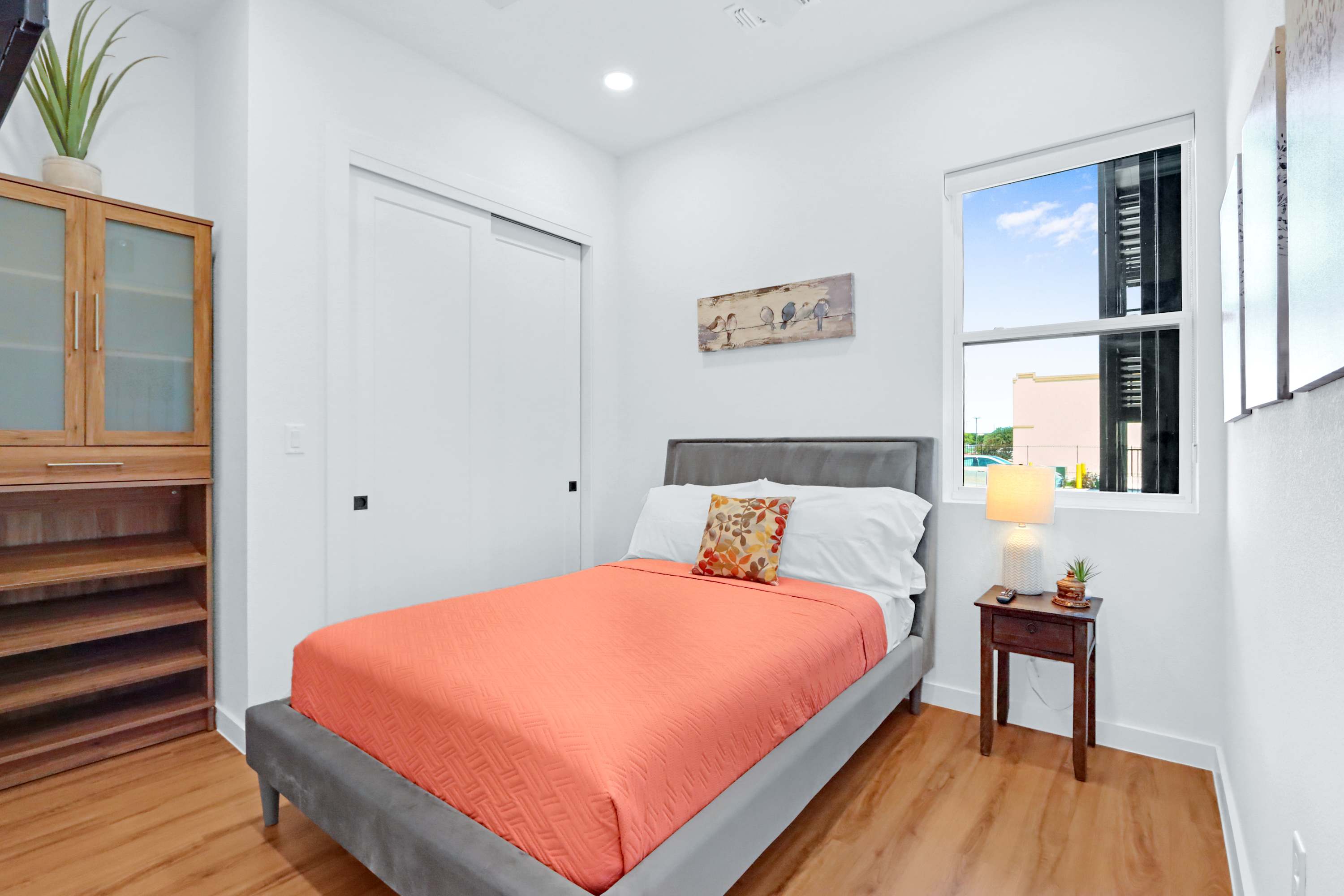 The serene bedroom suite boasts a full bed, ensuite bath, & smart TV