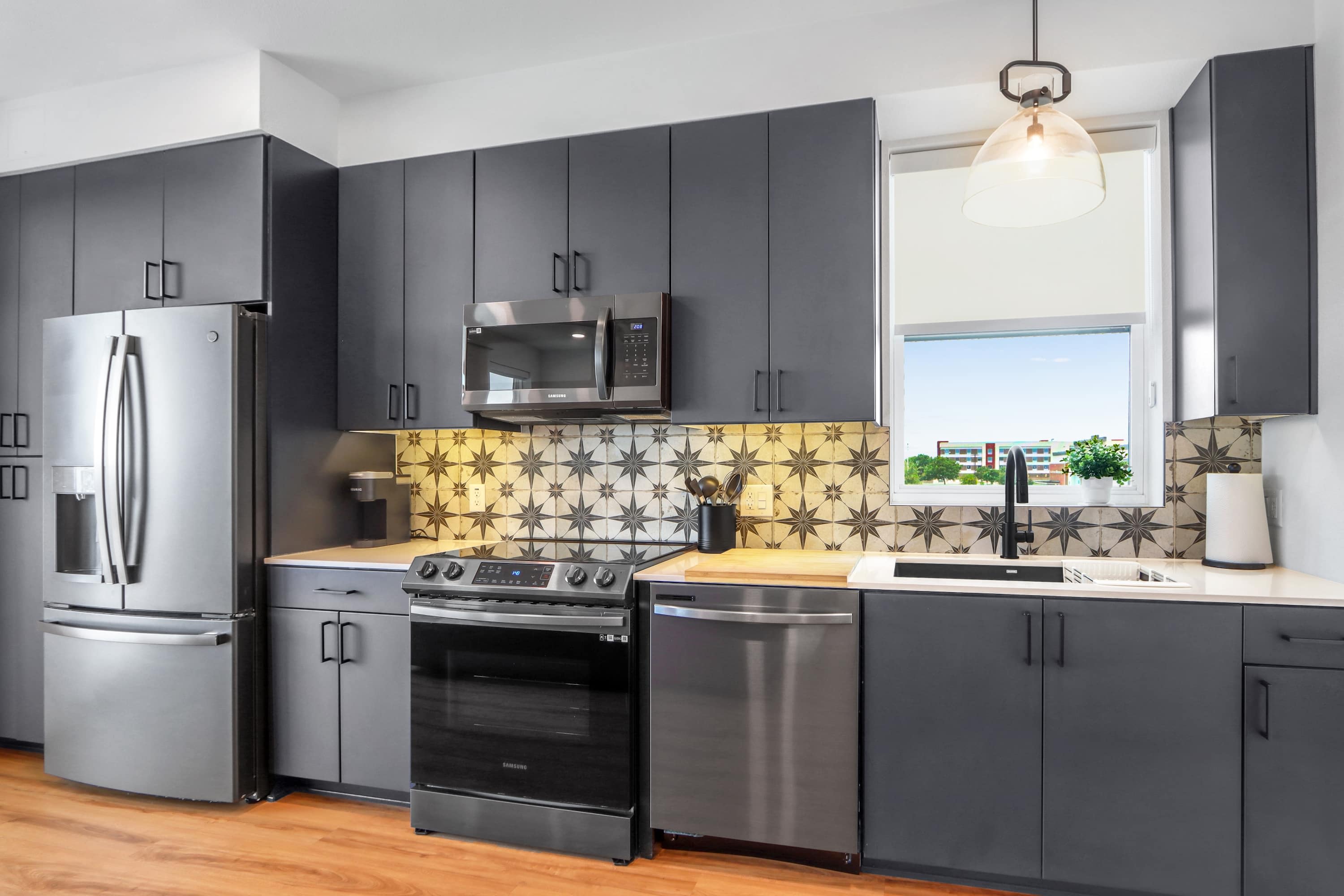The sleek, open kitchen offers ample space & every home comfort