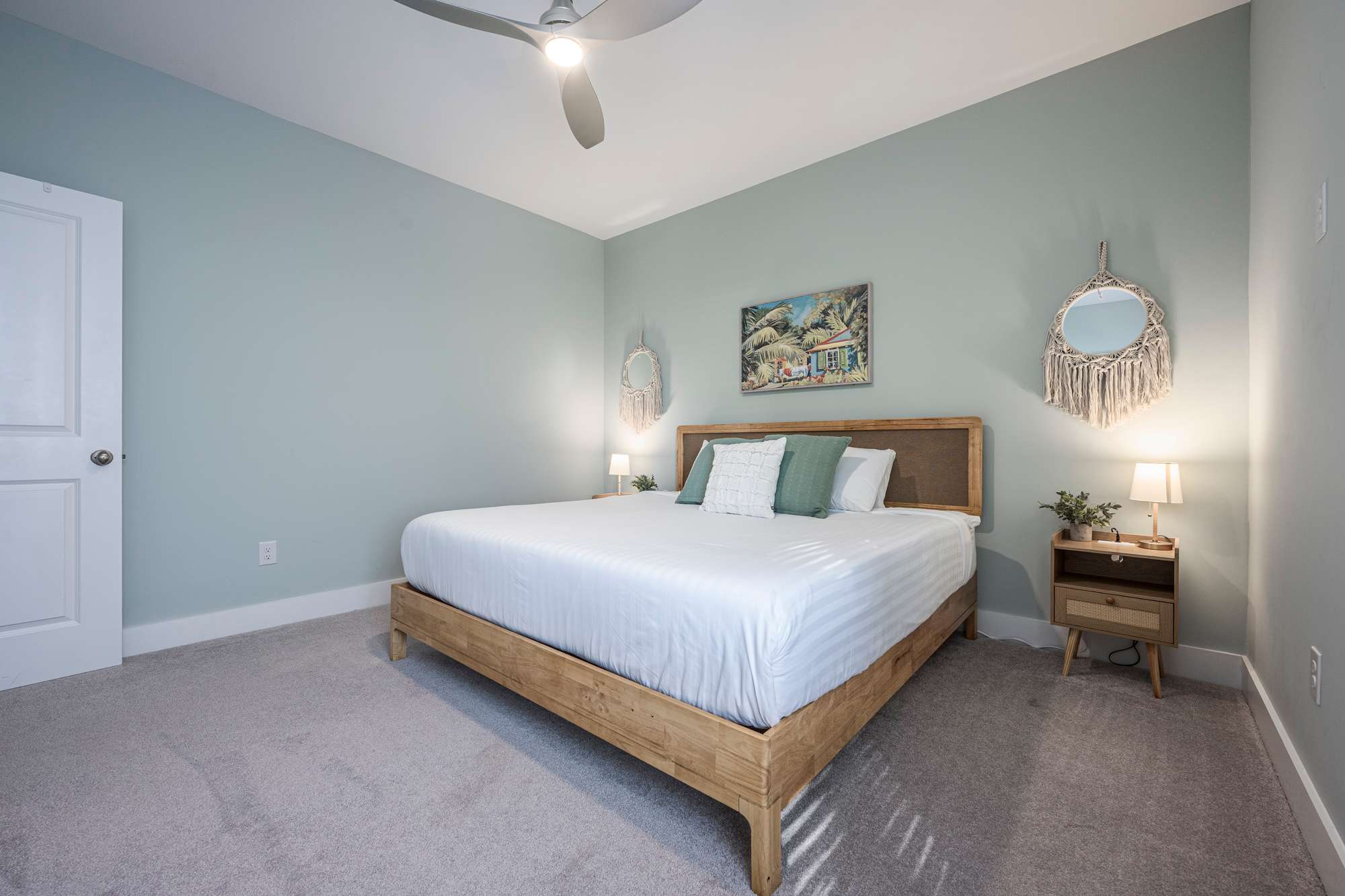 Drift into a peaceful night's sleep in this beautifully styled king bedroom, featuring cozy lighting and a relaxing coastal vibe.