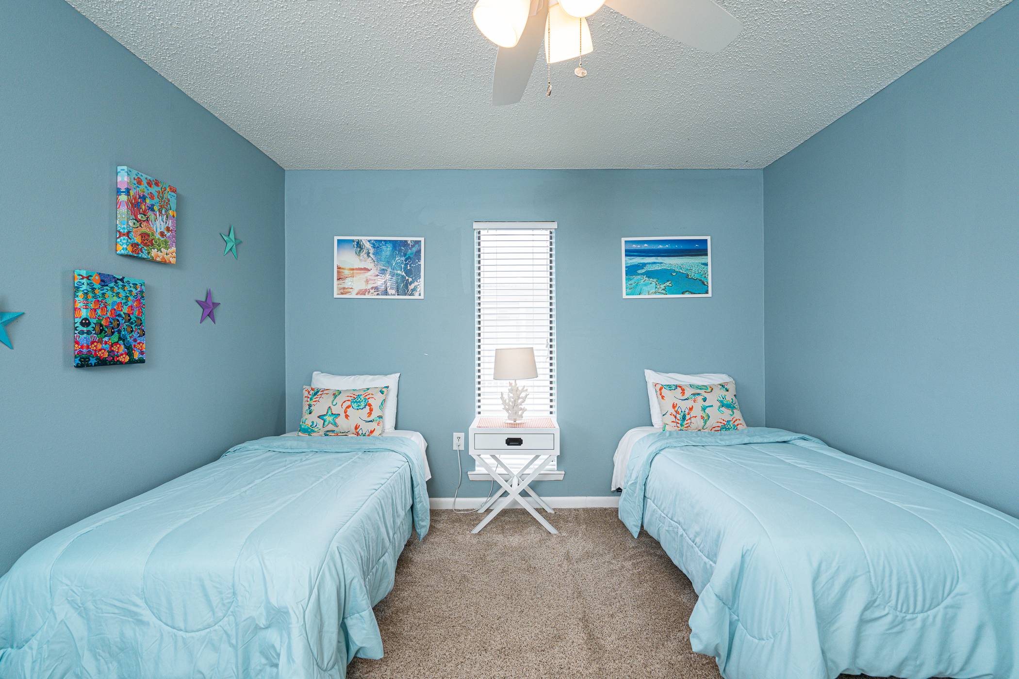 The 1st of 2 upper-level bedrooms is ideal for kids, featuring a pair of plush twin beds