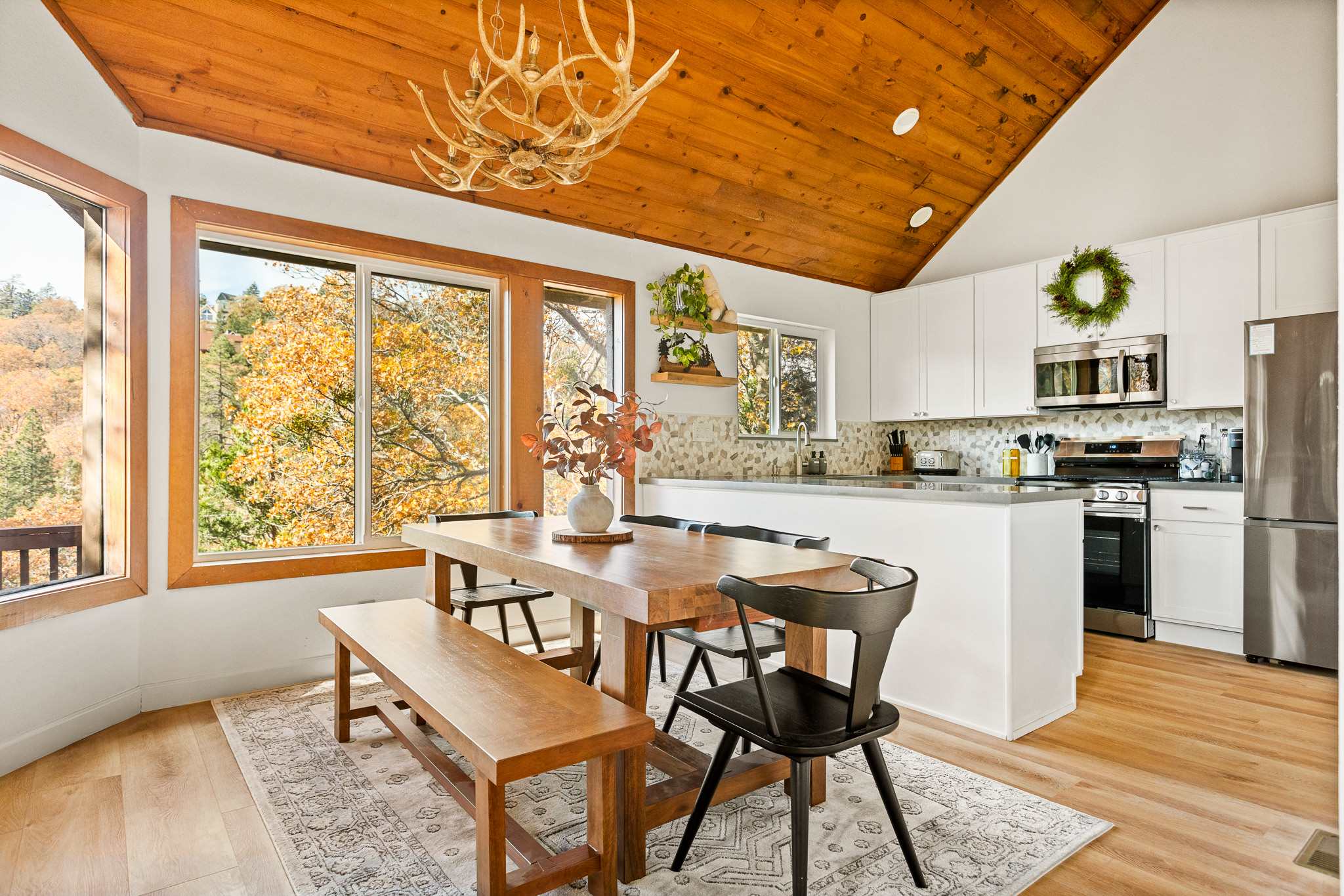 Gather for meals together at the dining table, with seating for the whole family, opens to the living room and the kitchen.