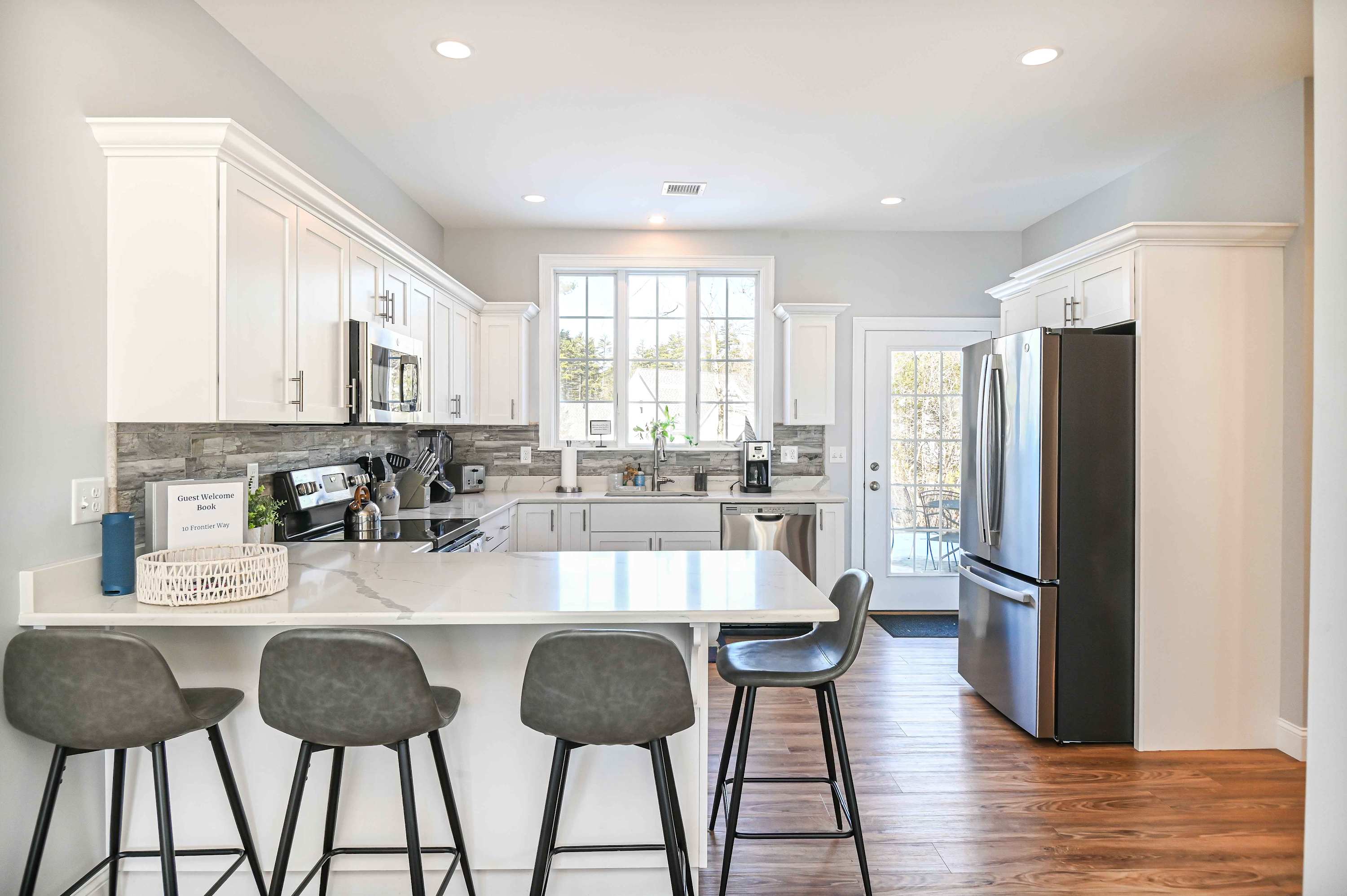 The airy kitchen offers ample space & all the comforts of home