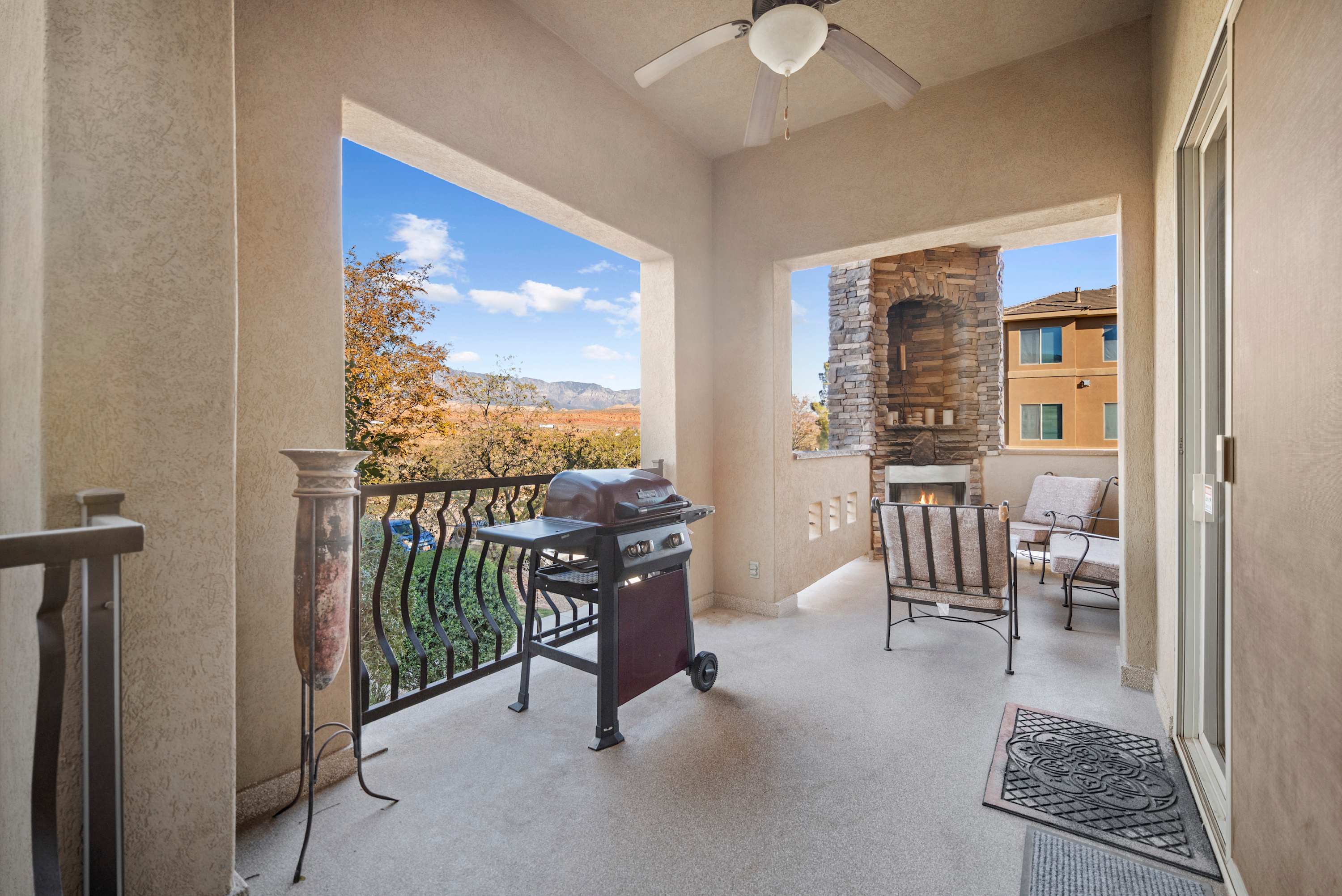 Private patio with outdoor dining, fireplace, and bbq