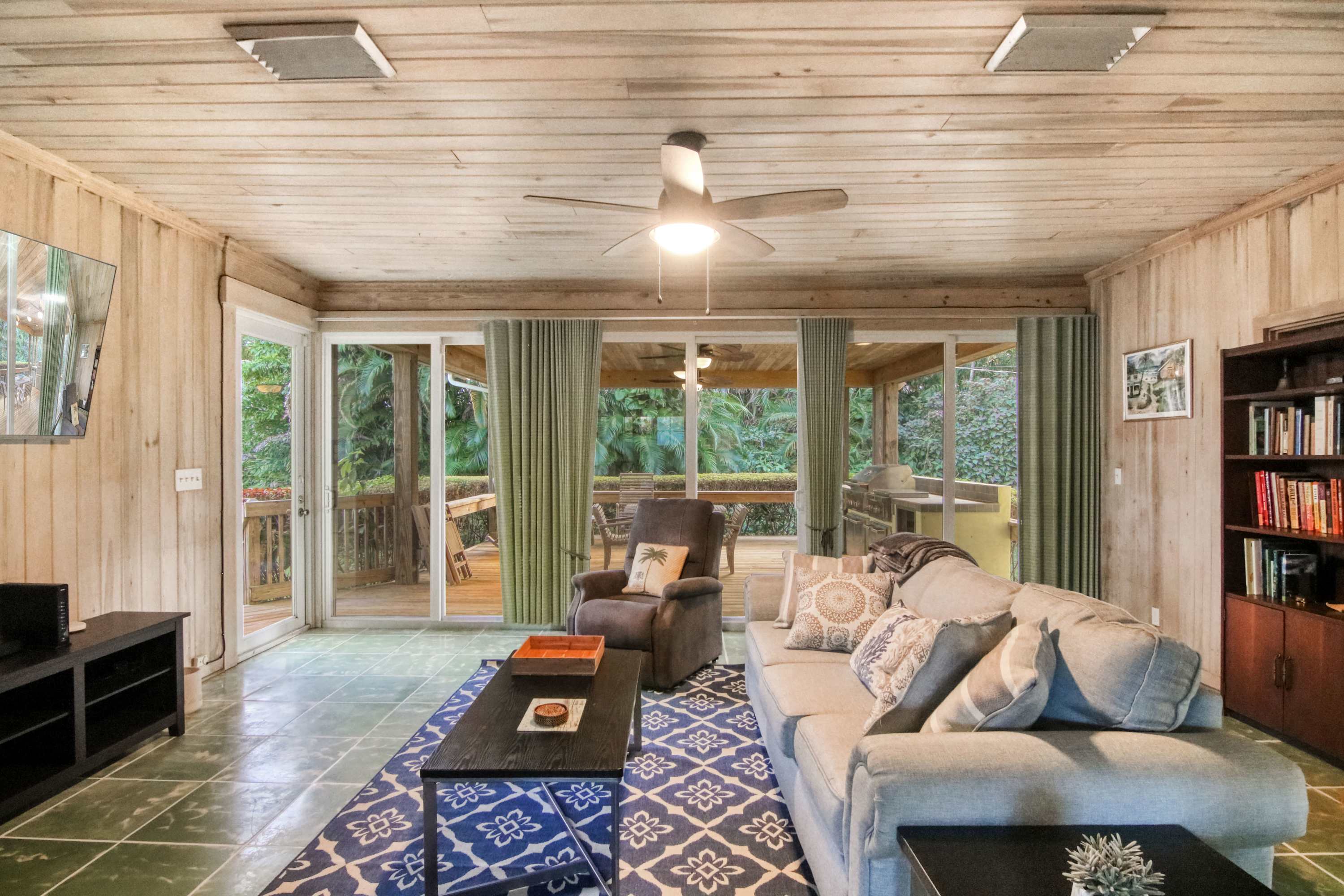 Cozy and spacious living area with floor-to-ceiling glass windows