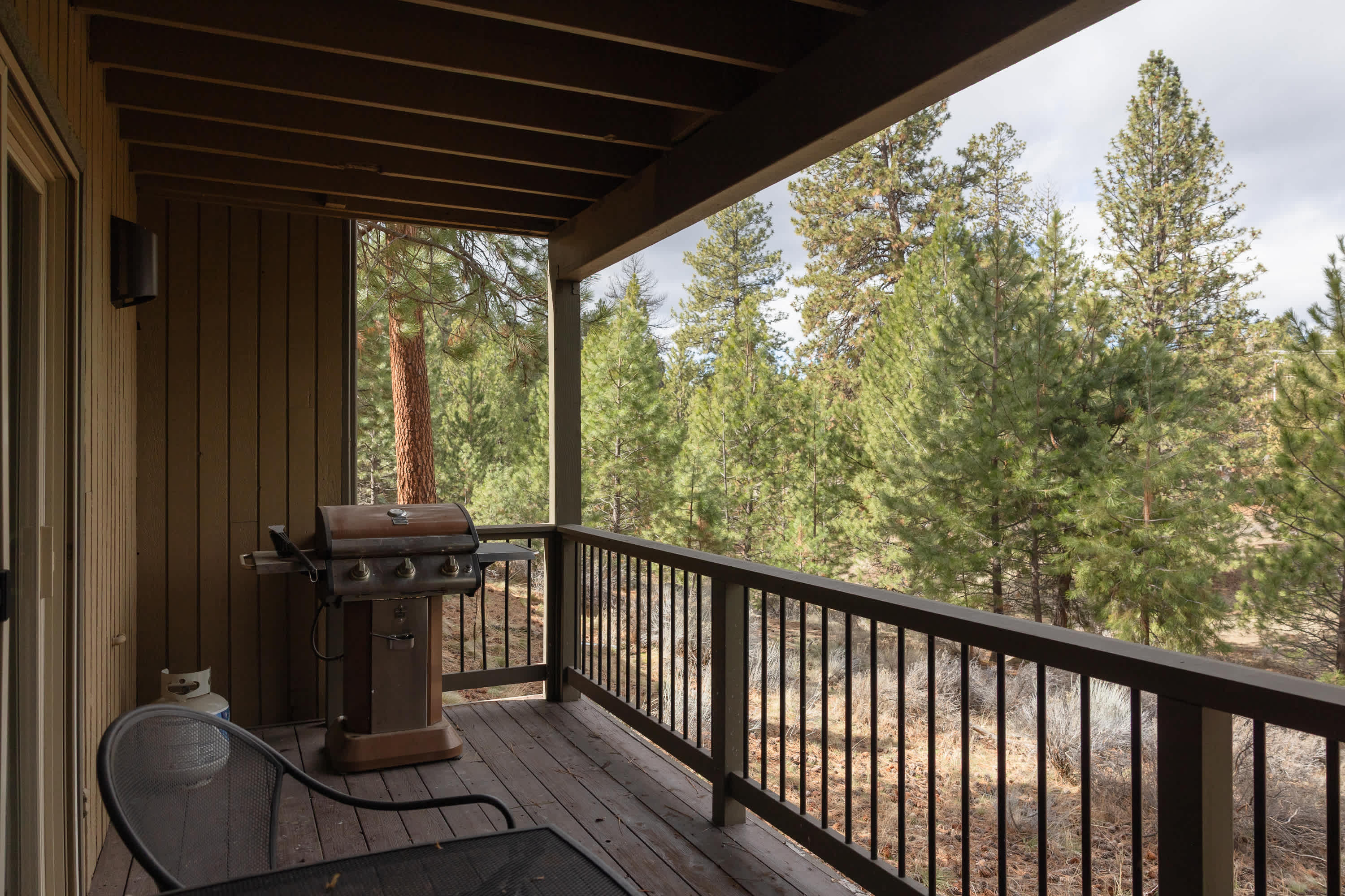 Balcony with BBQ grill and seating, ideal for outdoor dining and lounging.