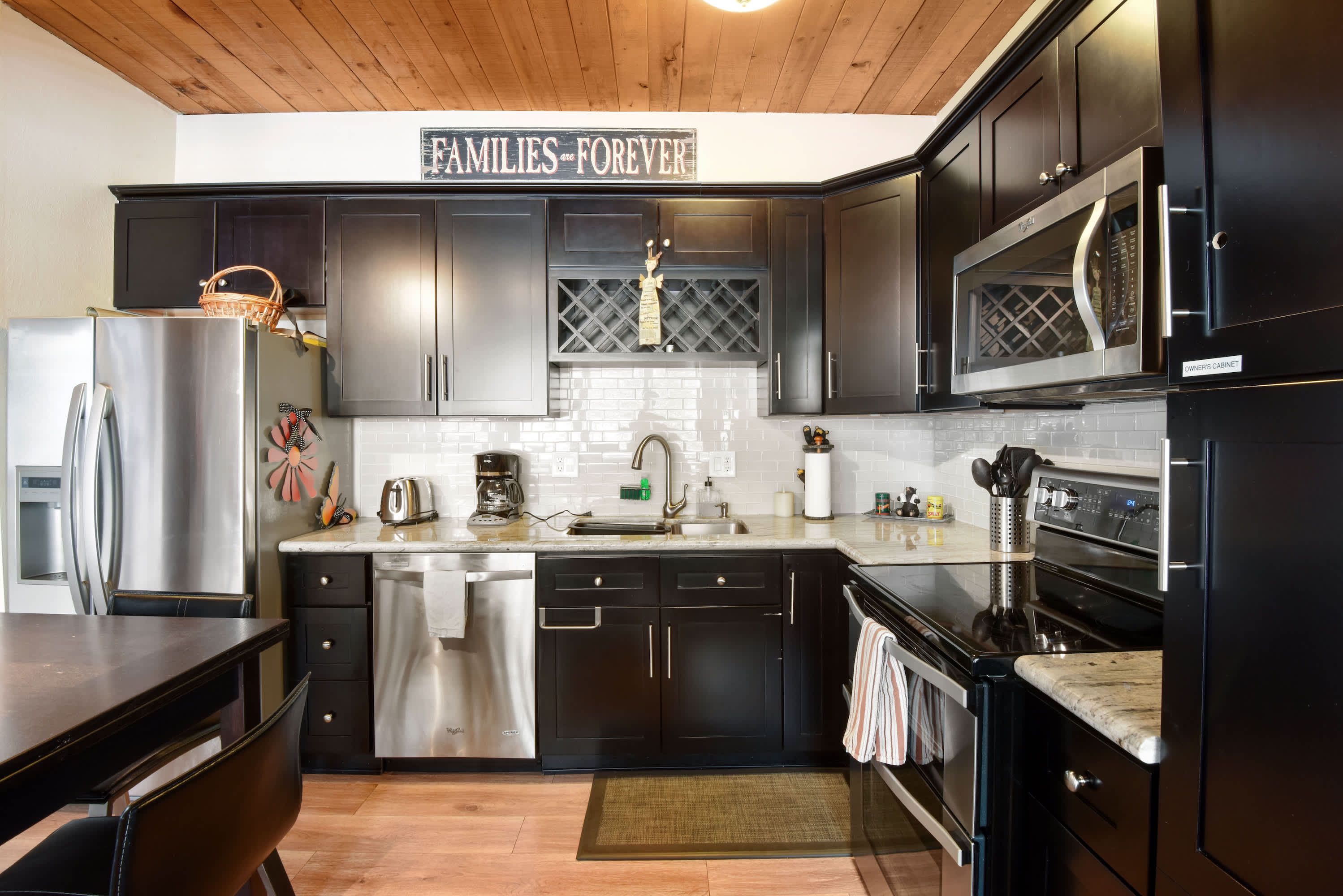 Modern kitchen with stainless steel appliances, drip coffee maker, knife set and more