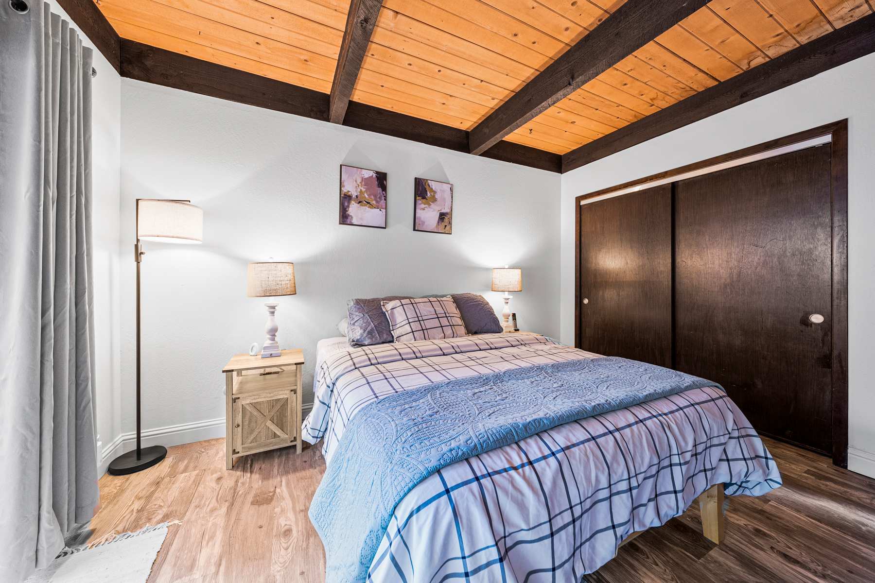 Cozy bedroom with a queen bed, smart TV, and direct access to the patio