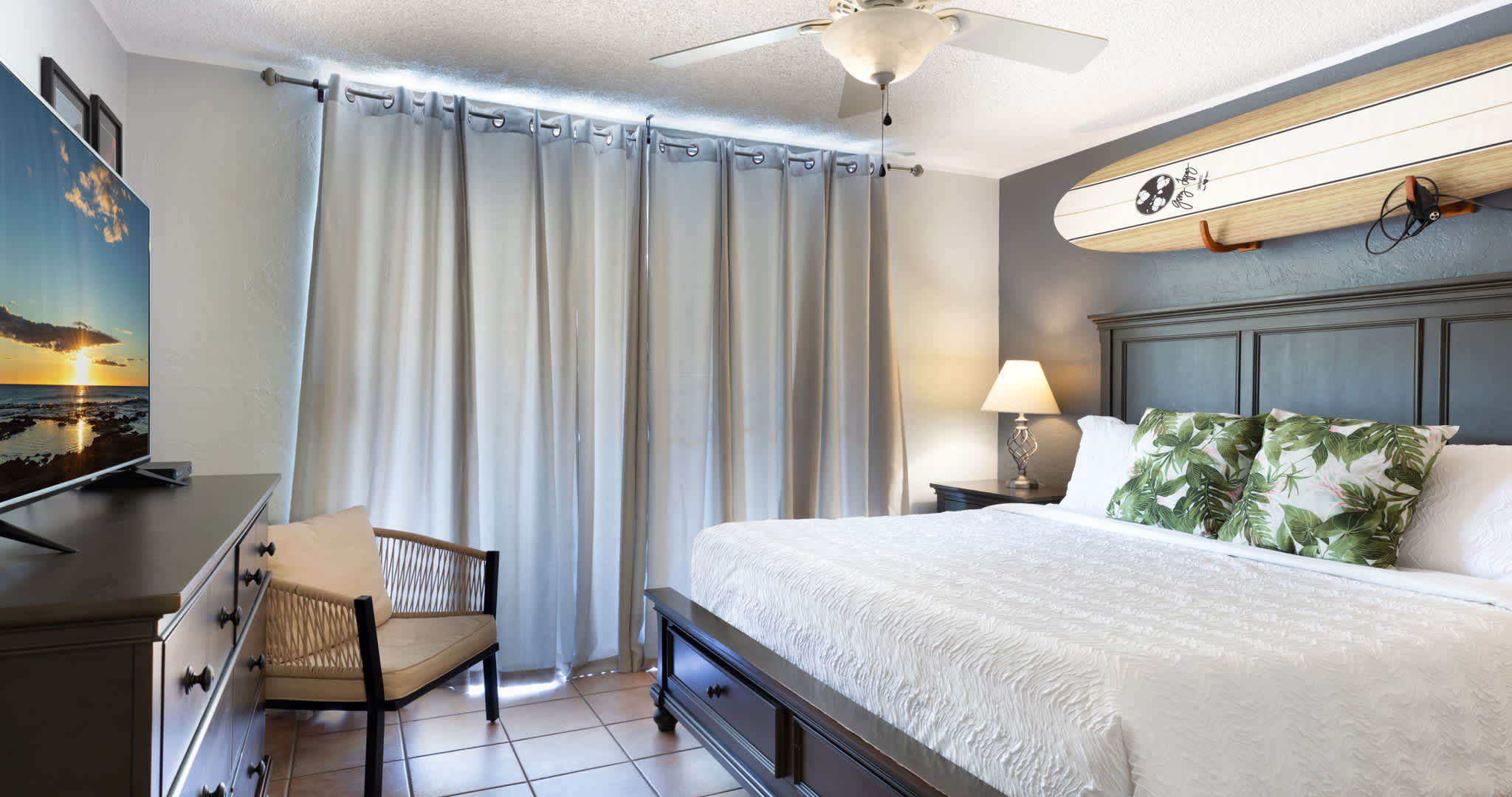 Bedroom one with king bed, lanai access, TV and en-suite