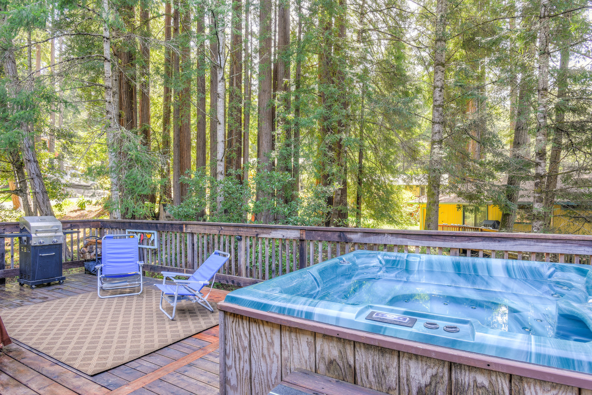 Hot tub with gas BBQ grill and lounge chairs