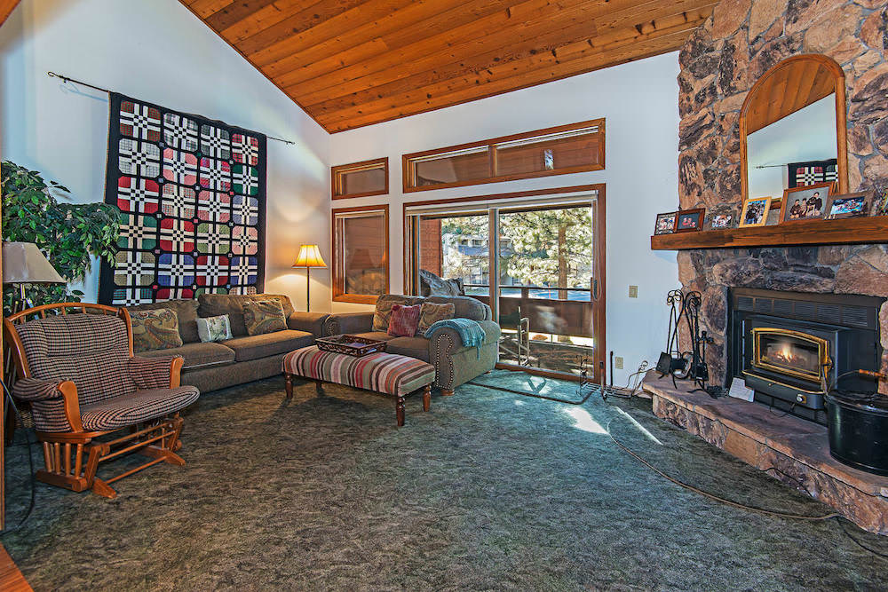 Living room w/ wood burning fireplace, board games, TV, DVD player