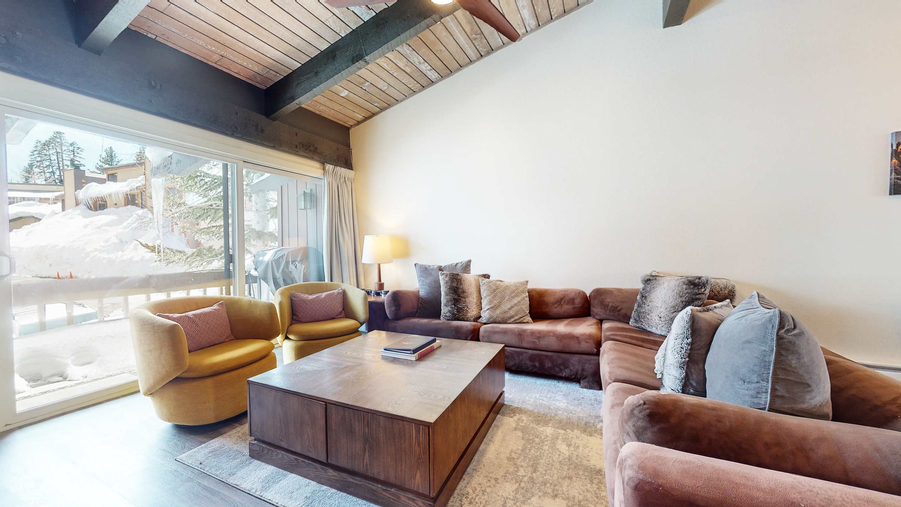 Floor-to-ceiling sliding glass doors in the living area