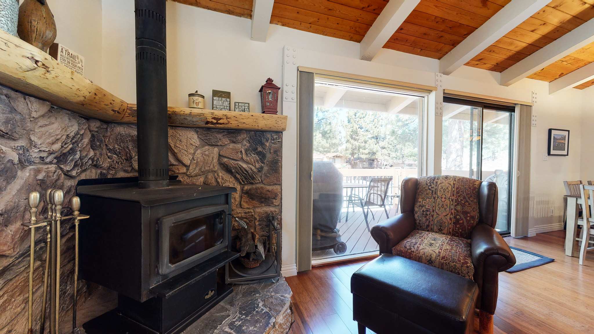 Cozy living space with fireplace, TV, and deck access