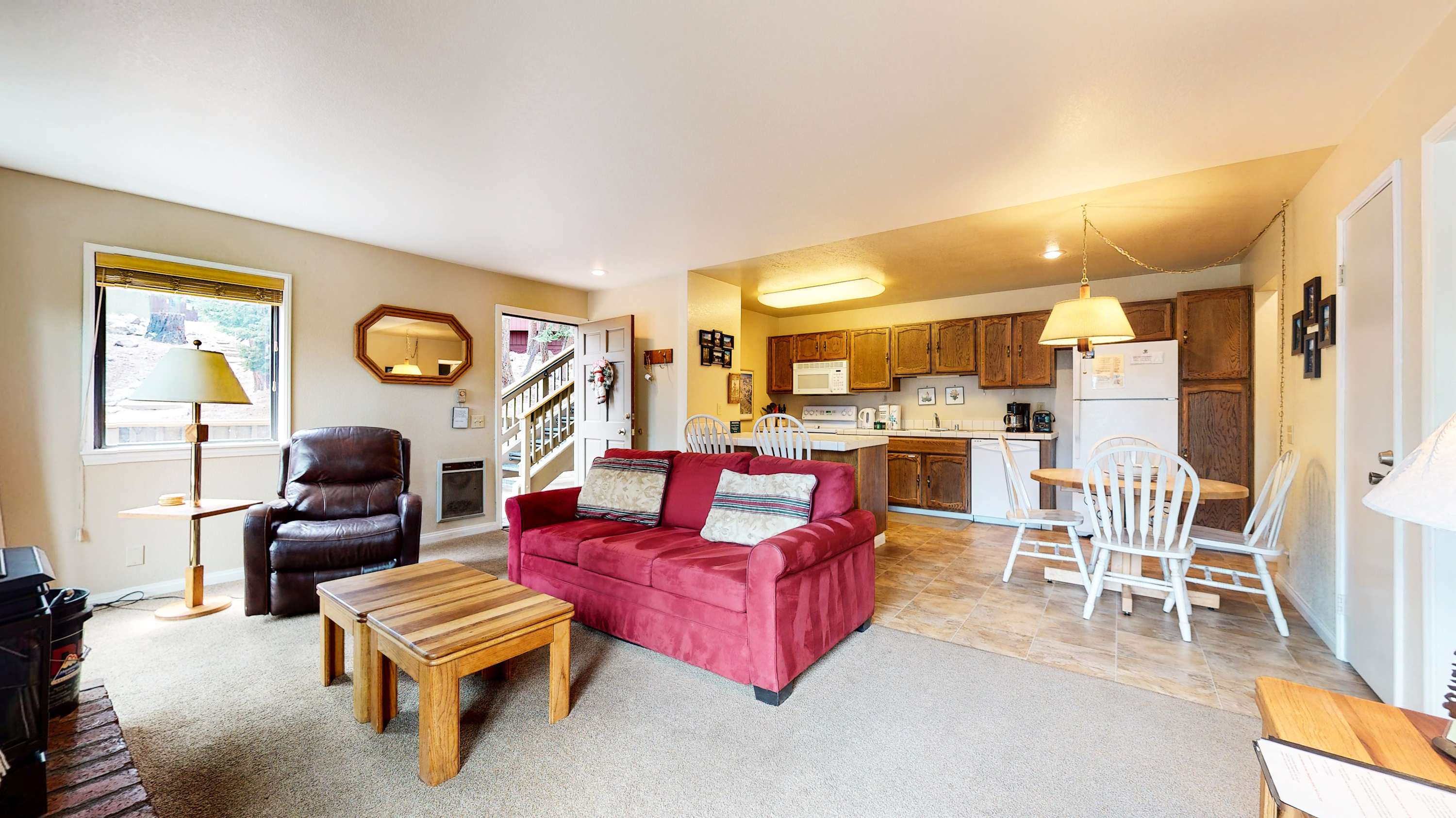 Living room with sofa sleeper, flat screen TV, and fireplace