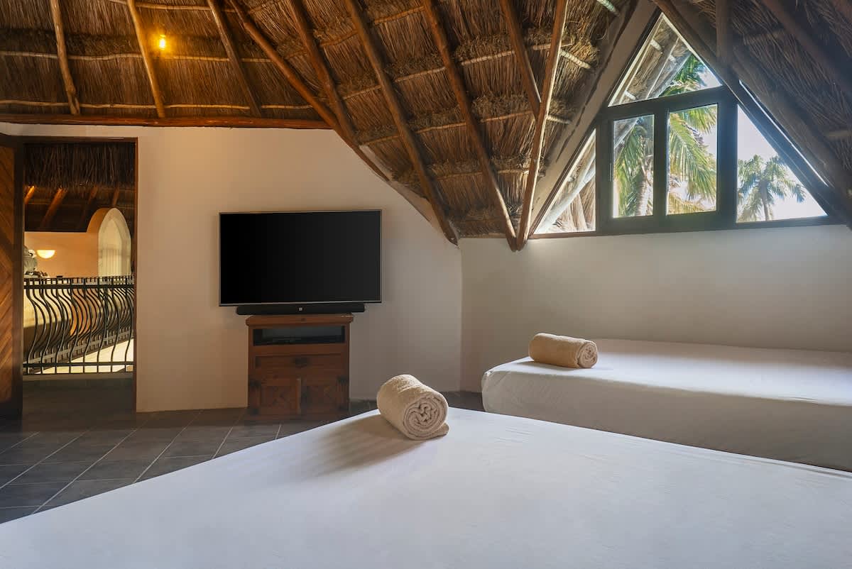 Bedroom number 3 with two double beds and a sofa bed.