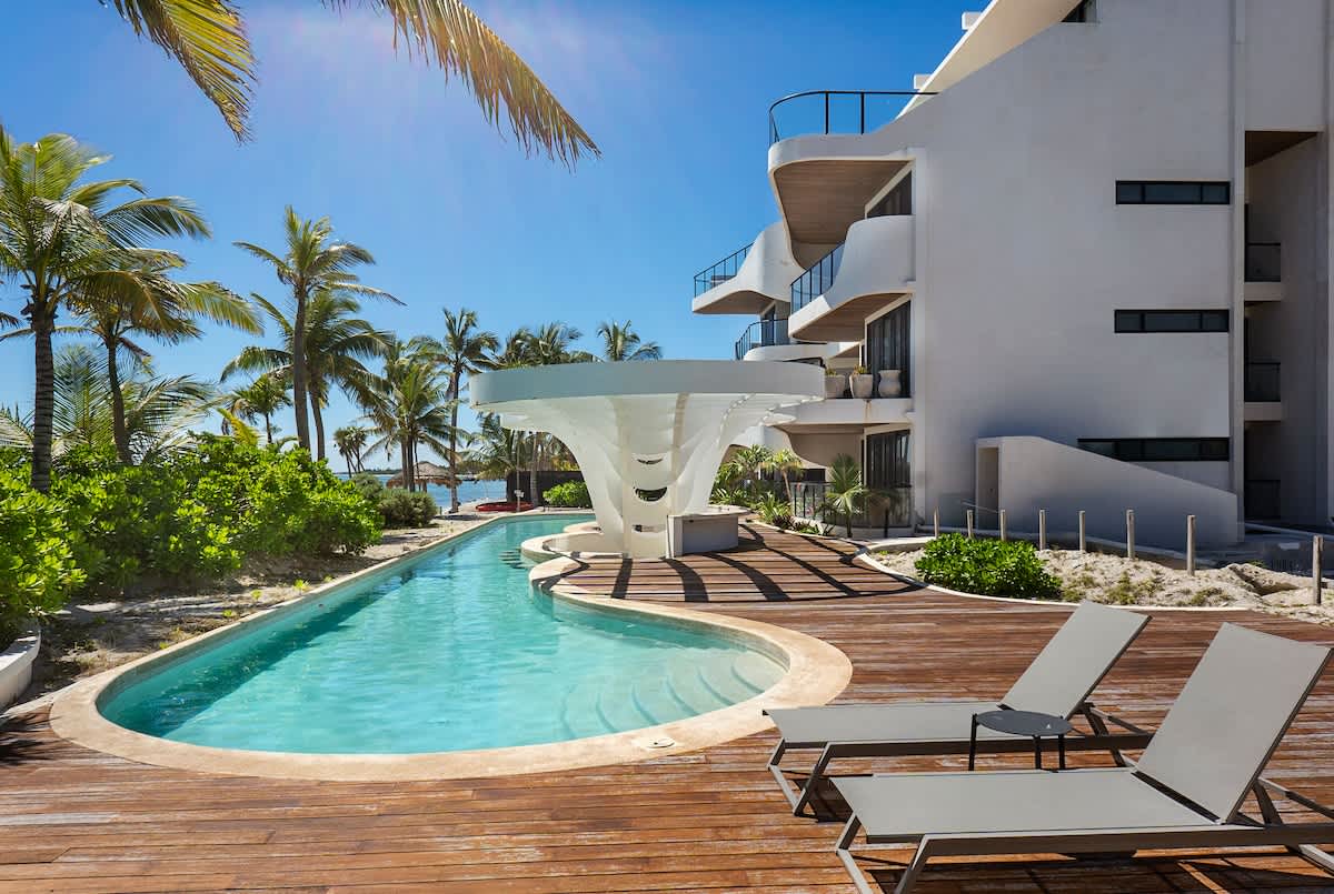 Beautiful sundeck in the complex. It features a pool, lounge chairs, and stunning ocean views.