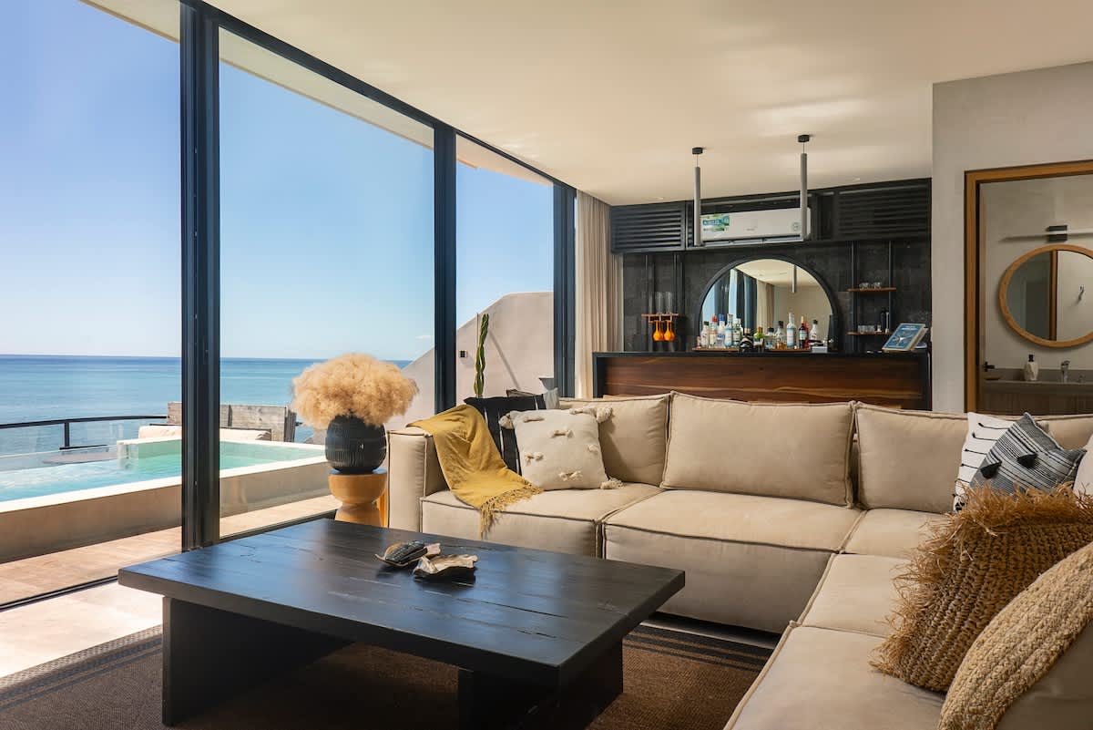 A modern living room featuring a stylish mini bar and charming décor