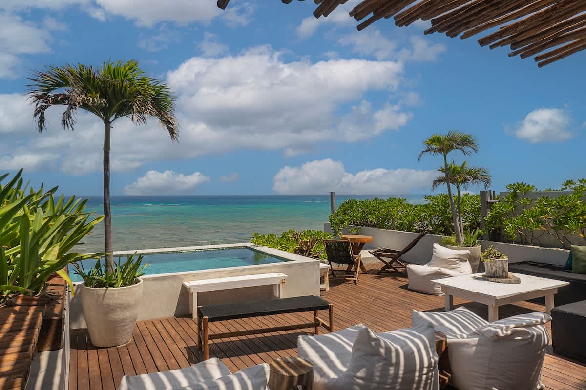 Private rooftop terrace with stunning ocean views, featuring comfortable outdoor furniture