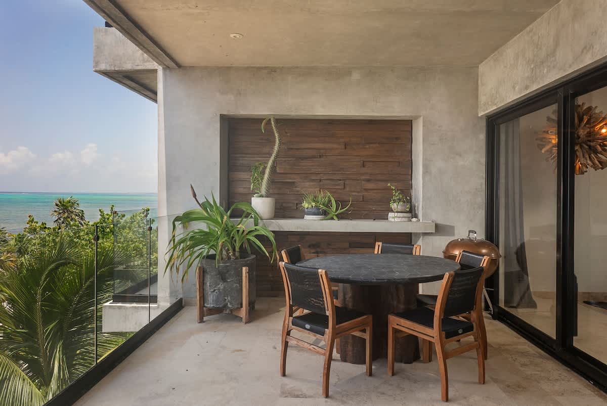Private balcony with ocean view and outdoor dining area