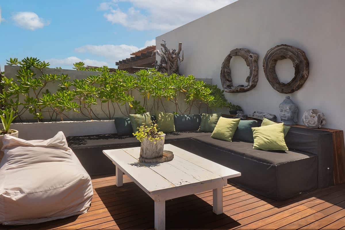 Private rooftop terrace with stunning ocean views, featuring comfortable outdoor furniture
