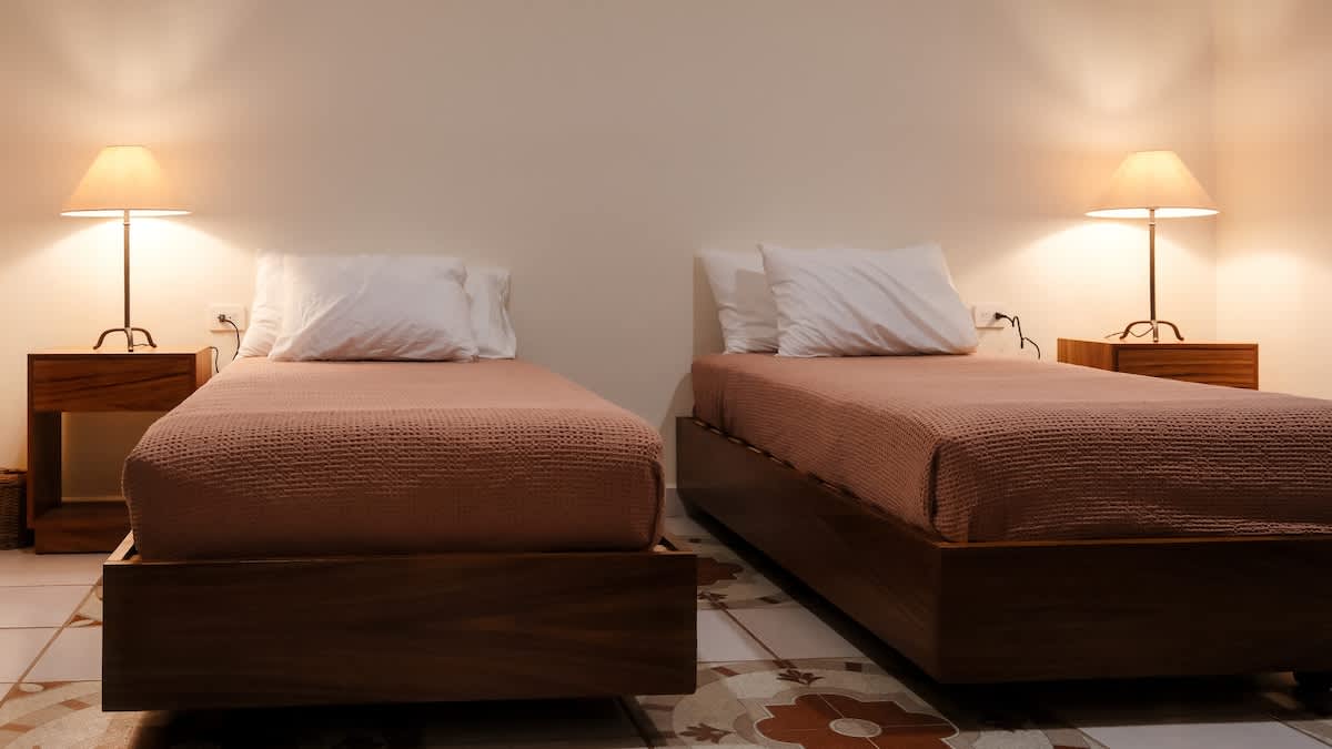 Bedroom #3: king-size bed (convert to 2 singles), featuring warm wood details and an en-suite bathroom