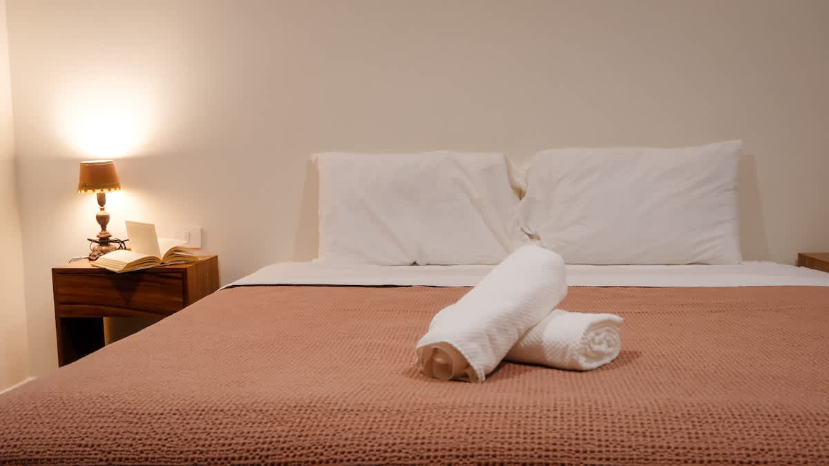 Bedroom #3: king-size bed (convert to 2 singles), featuring warm wood details and an en-suite bathroom