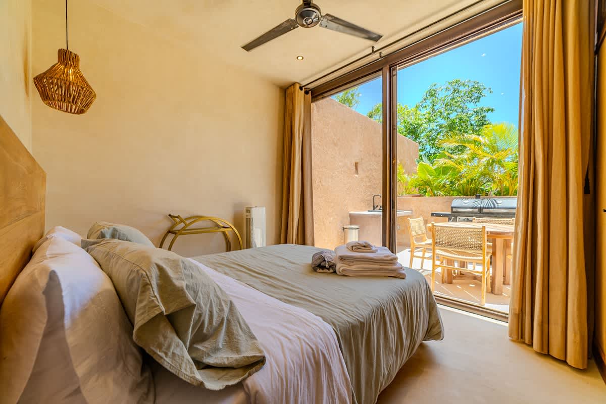Relaxing bedroom with natural light and a tranquil atmosphere for a restful night’s sleep.