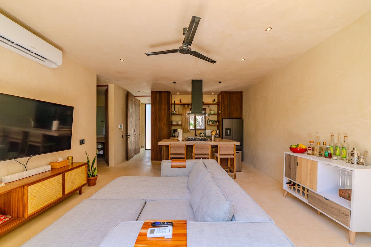 Spacious and bright living room with Smart TV, comfortable seating.