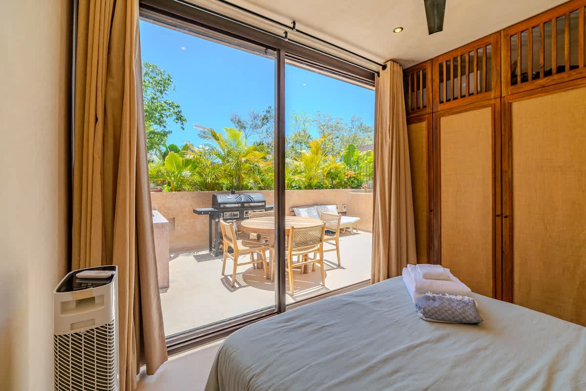 Relaxing bedroom with natural light and a tranquil atmosphere for a restful night’s sleep.