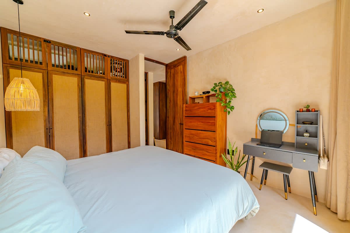 1 King size bed -Peaceful bedroom designed for comfort, featuring a cozy bed and calming jungle surroundings.