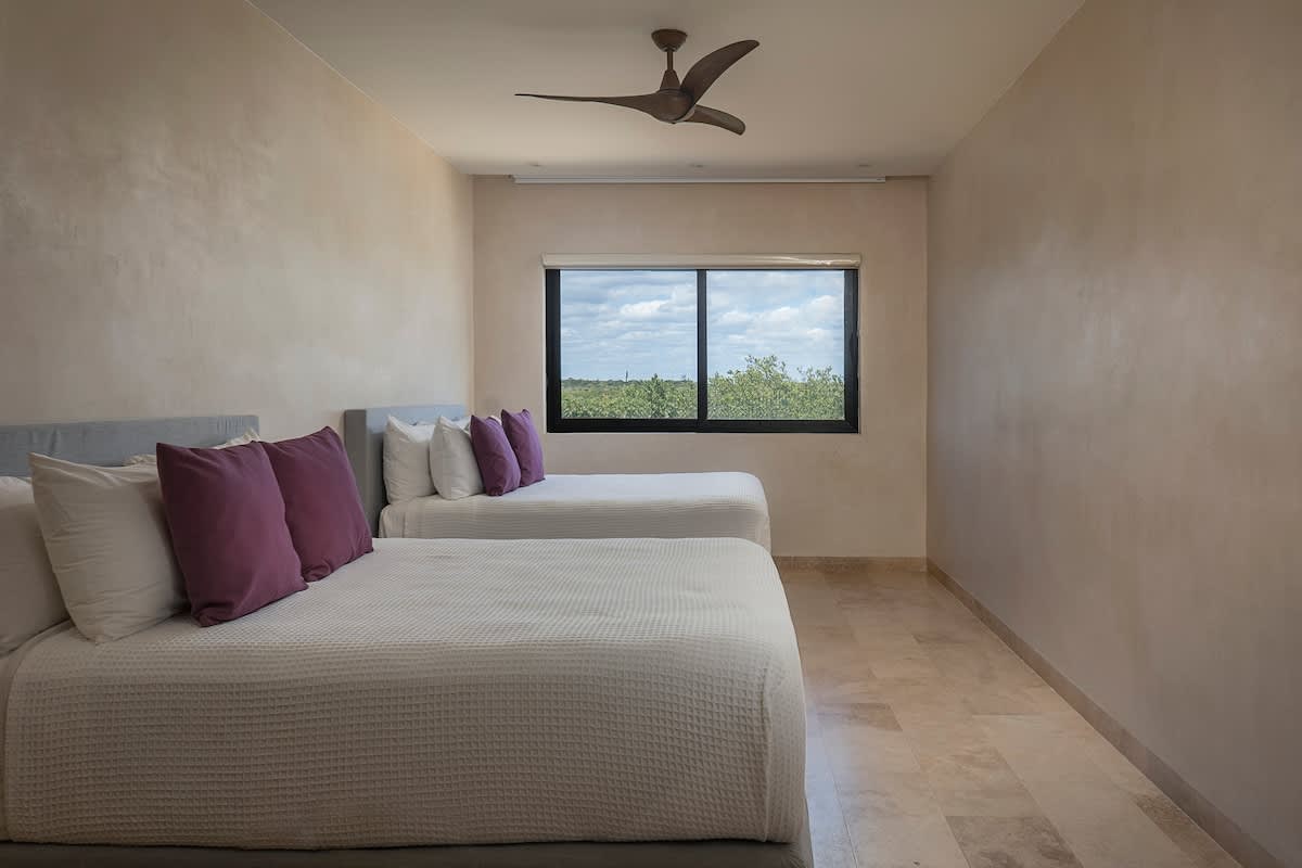Bedroom #1 features two comfortable queen beds and beautiful jungle views, creating the perfect relaxing retreat.
