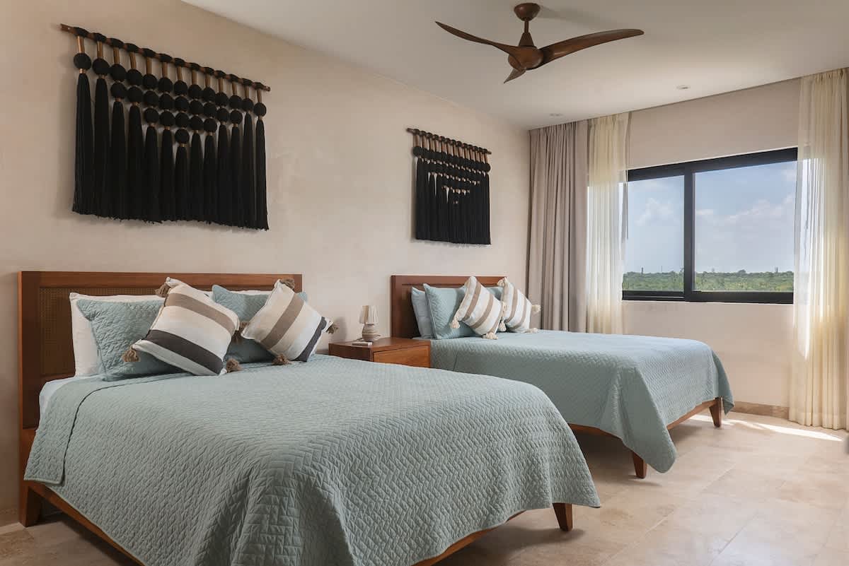 Bedroom #6 features two comfortable queen beds and beautiful jungle views, creating the perfect relaxing retreat.