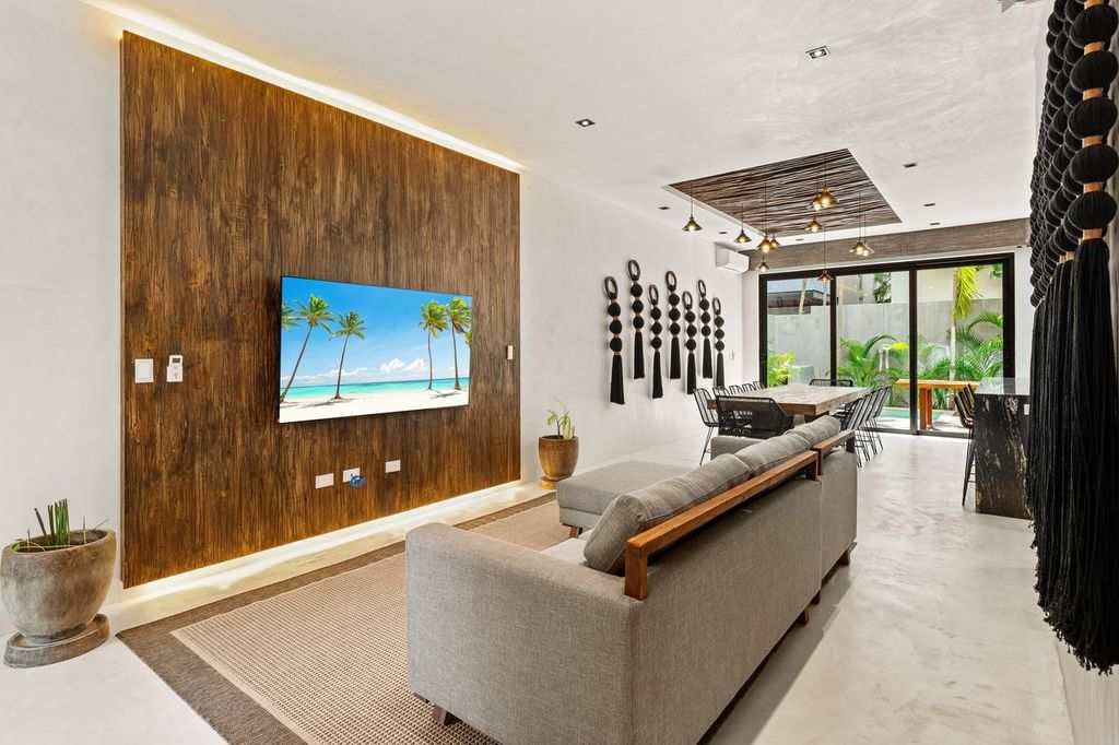 Bright and inviting living room, thoughtfully designed with a comfortable sofa and TV for cozy moments and relaxation.