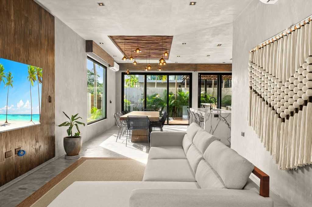 Bright and inviting living room, thoughtfully designed with a comfortable sofa and TV for cozy moments and relaxation