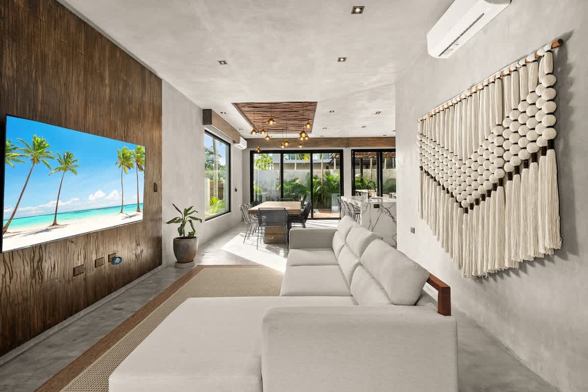 Bright and inviting living room, thoughtfully designed with a comfortable sofa and TV for cozy moments and relaxation
