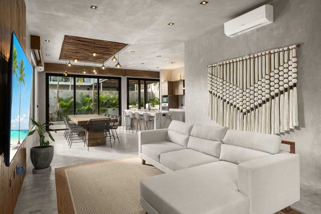 Bright and inviting living room, thoughtfully designed with a comfortable sofa and TV for cozy moments and relaxation